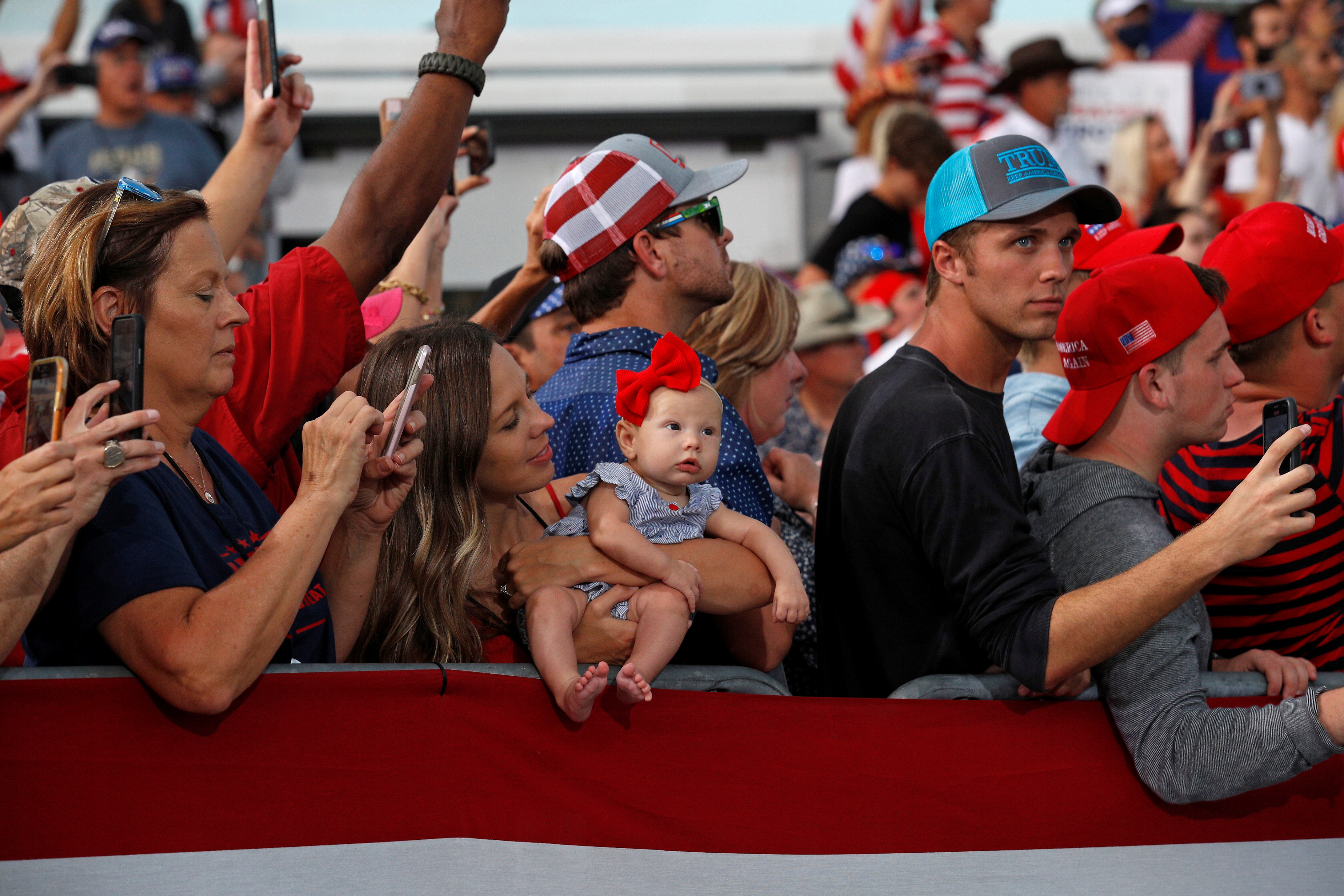 People crowd together without masks to attend a campaign rally by President Donald Trump at Cecil Airport in Jacksonville, Florida, on September 24, 2020.