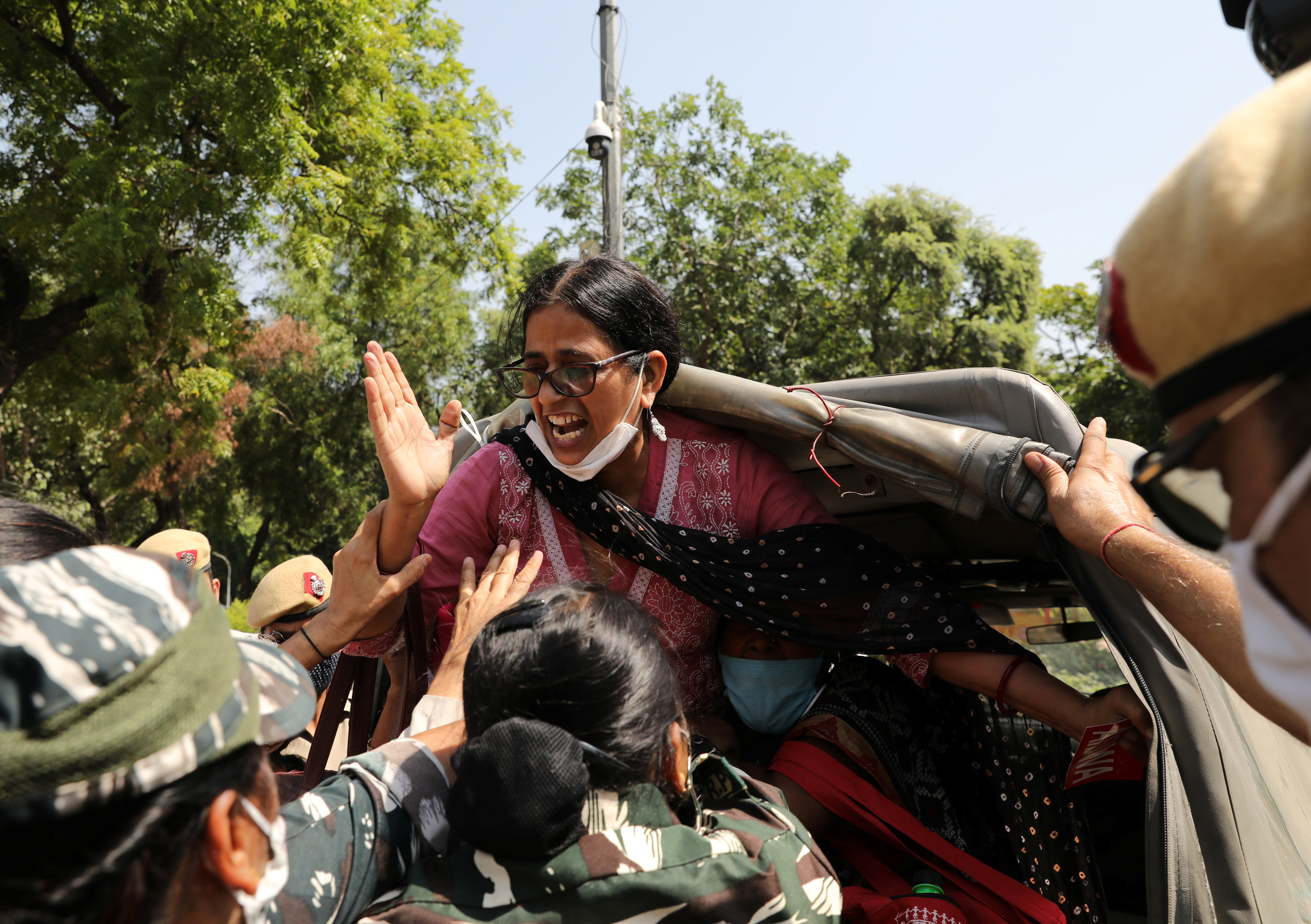 A demonstrator is arrested by police during a protest outside Uttar Pradesh’s state bhavan (building) in New Delhi, following the woman’s rape and murder