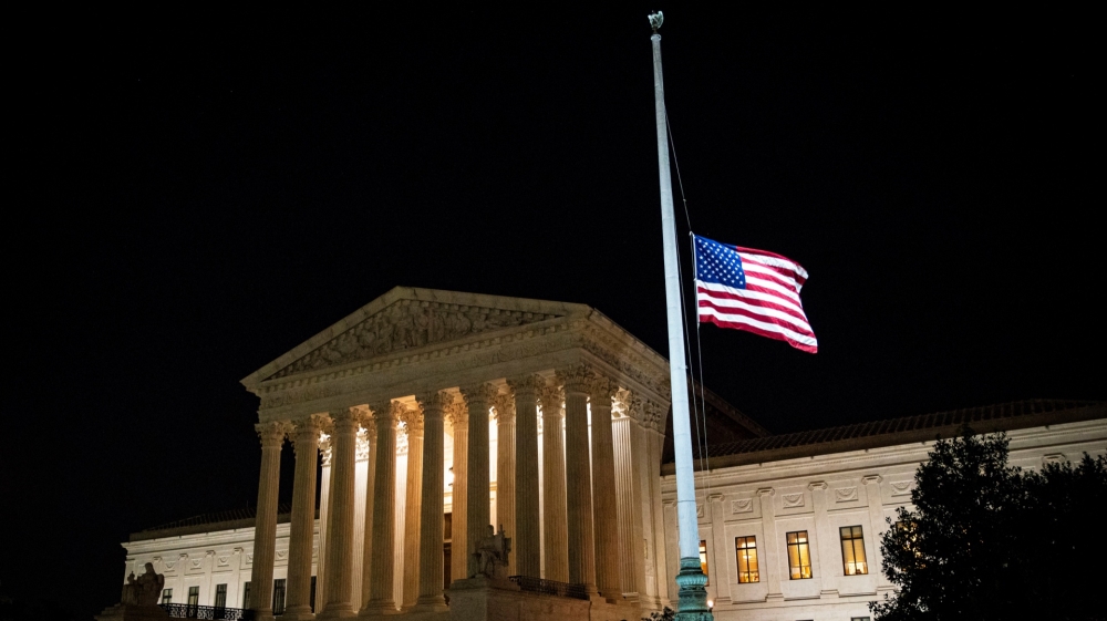 The US flag flies at half-staff outside of the US Supreme Court in Washington, DC, on Friday