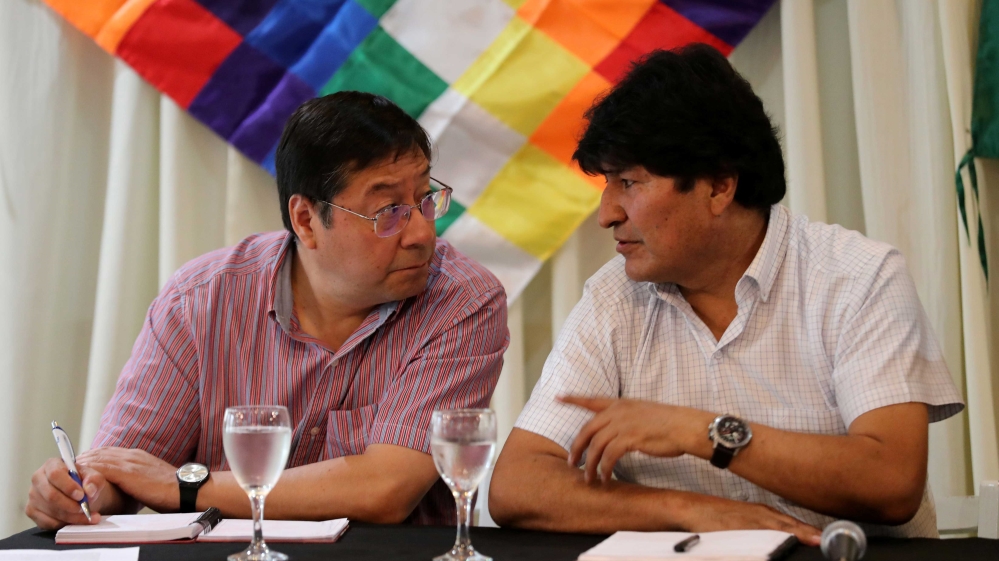 Evo Morales speaking to the presidential candidate for the Movement to Socialism party (MAS) Luis Arce during a meeting of their party, in Buenos Aires, Argentina