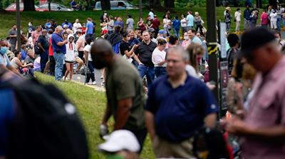 Hundreds of people line up outside a Kentucky Career Center hoping to find assistance with their unemployment claim in Frankfort, Kentucky in June