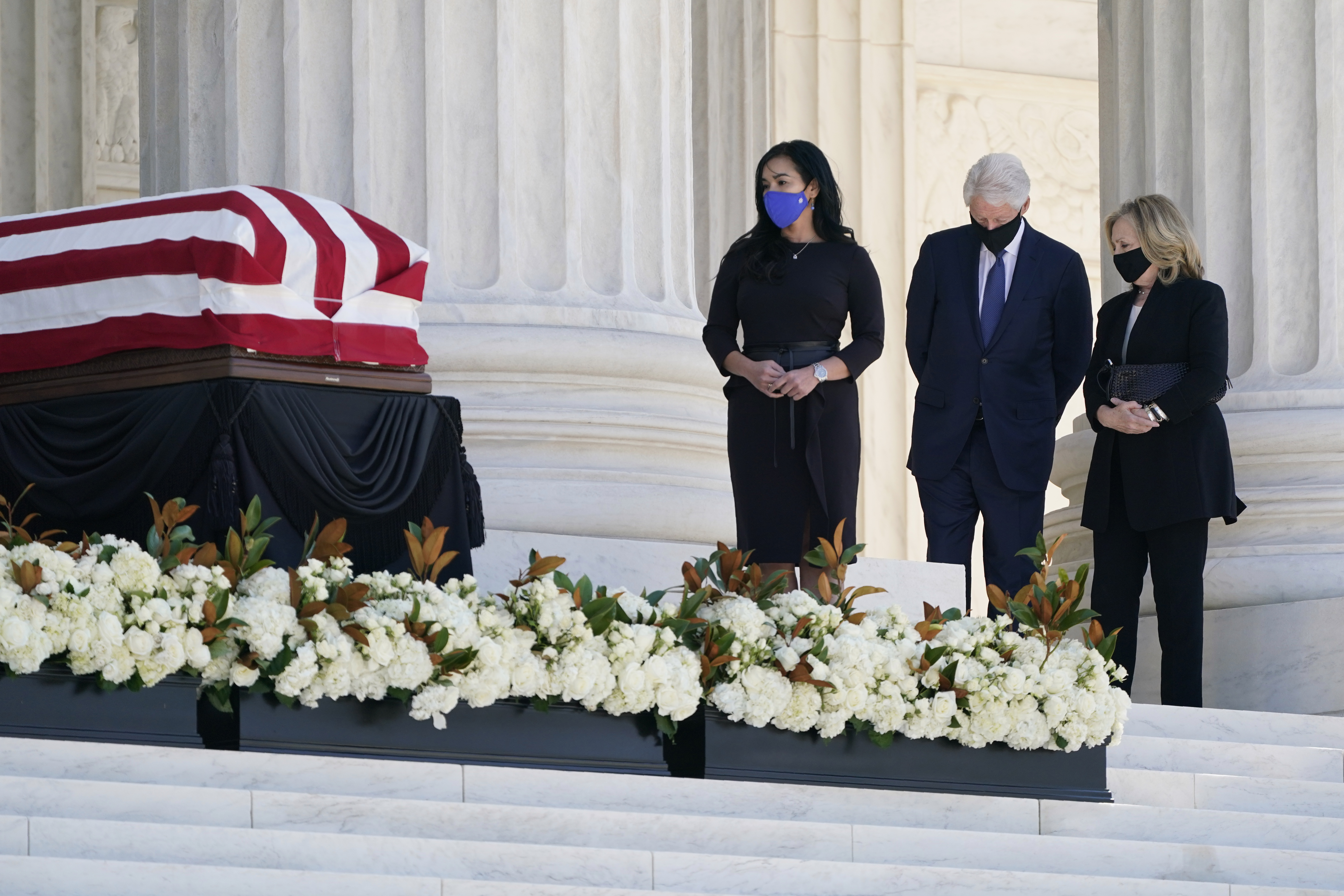 Former President Bill Clinton and former Secretary of State Hillary Clinton pay respects as Justice Ruth Bader Ginsburg lies in repose under the Portico at the top of the front steps of the Supreme Court