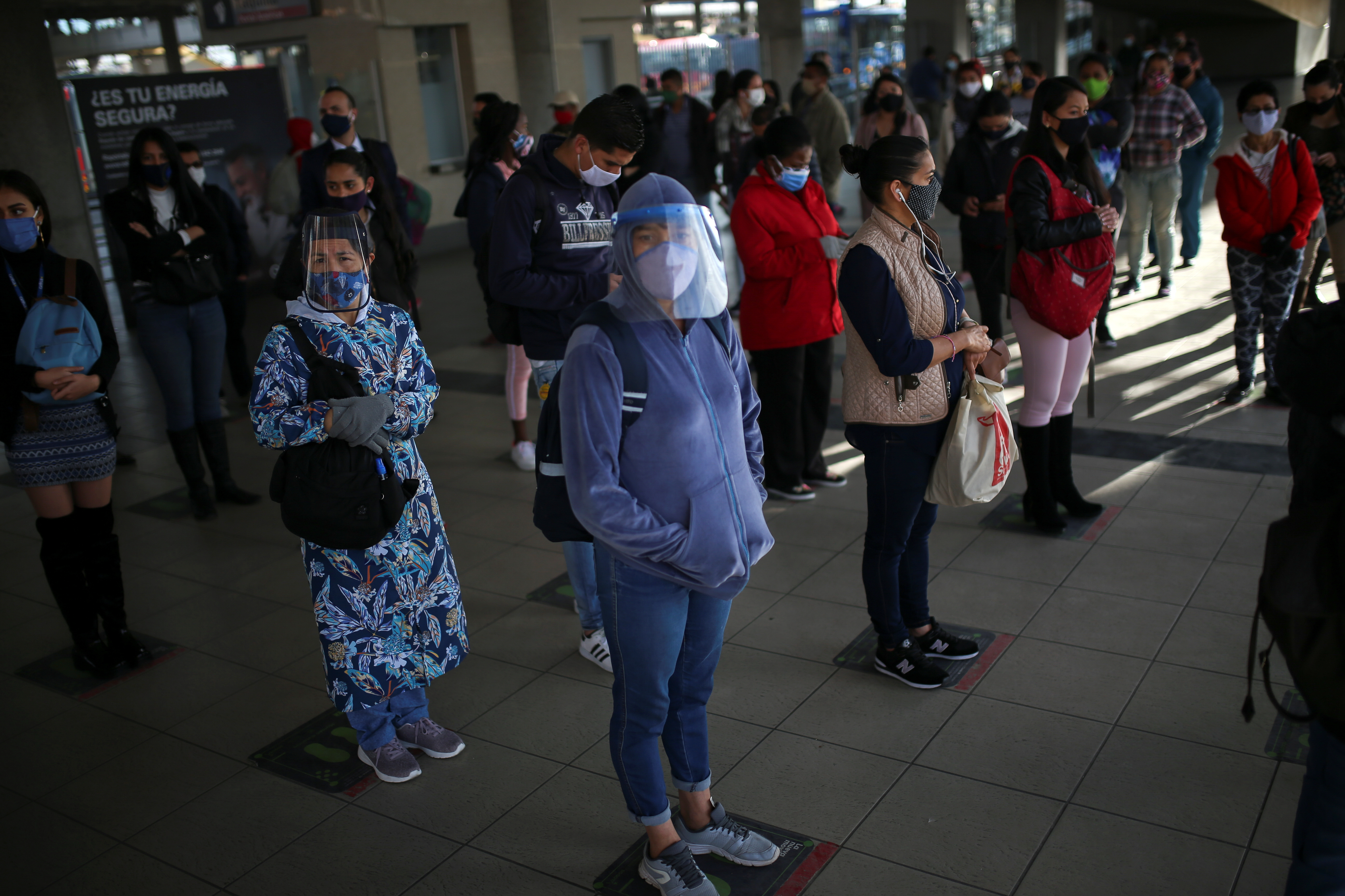 People wearing protective masks during the coronavirus outbreak in Bogota, Colombia, where the wider Latin American region is likely to be particularly hard hit with a drop in output this year of 7.6 percent