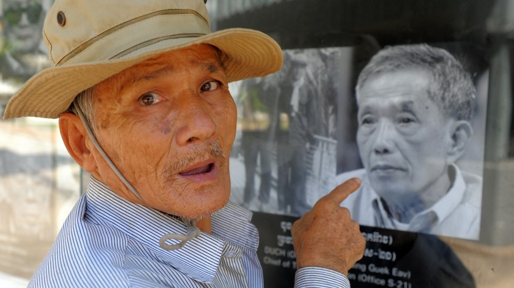 Bou Meng, a Cambodian survivor of Tuol Sleng prison, points at a picture of Duch, in this photo taken on January 31, 2012, in Phnom Penh