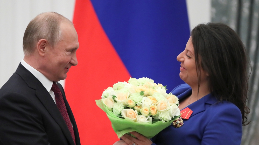Russia’s President Vladimir Putin presents flowers to editor-in-chief of Russian broadcaster RT Margarita Simonyan after decorating her with the Order of Alexander Nevsky during a ceremony at the Kremlin in Moscow, Russia