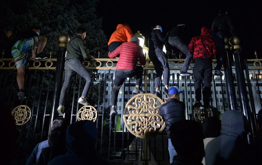 Protesters attempt to break through the gates of the government headquarters during a rally against the results of a parliamentary vote in Bishkek on October 5, 2020