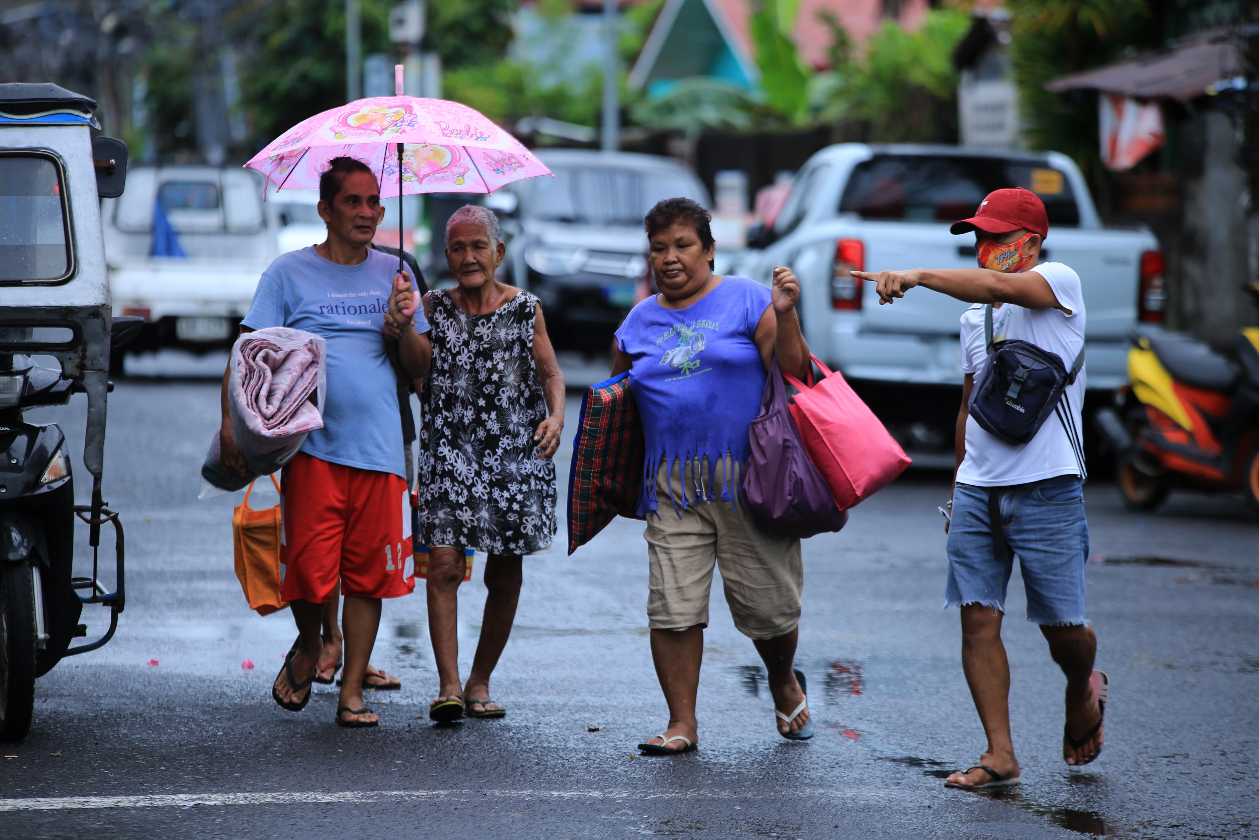Residents evacuate from their home in the coastal area of Legaspi City, Albay province south of Manila on October 25, 2020, in advance of tropical storm Molave’s expected landfall