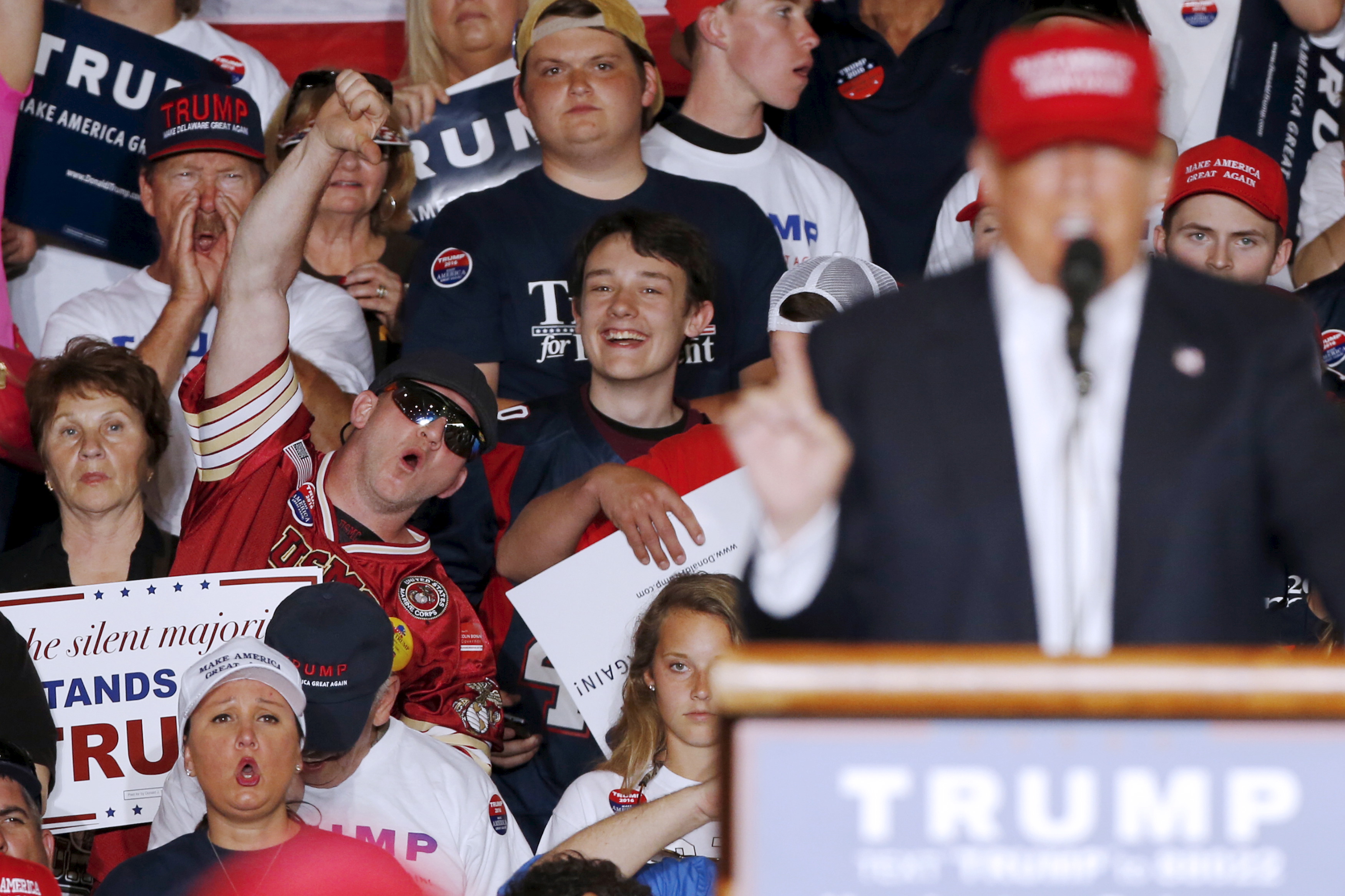 Supporters of US Republican presidential candidate Donald Trump, right, react with boos when he mentions Obamacare during a rally in Harrington, Delaware April 22, 2016