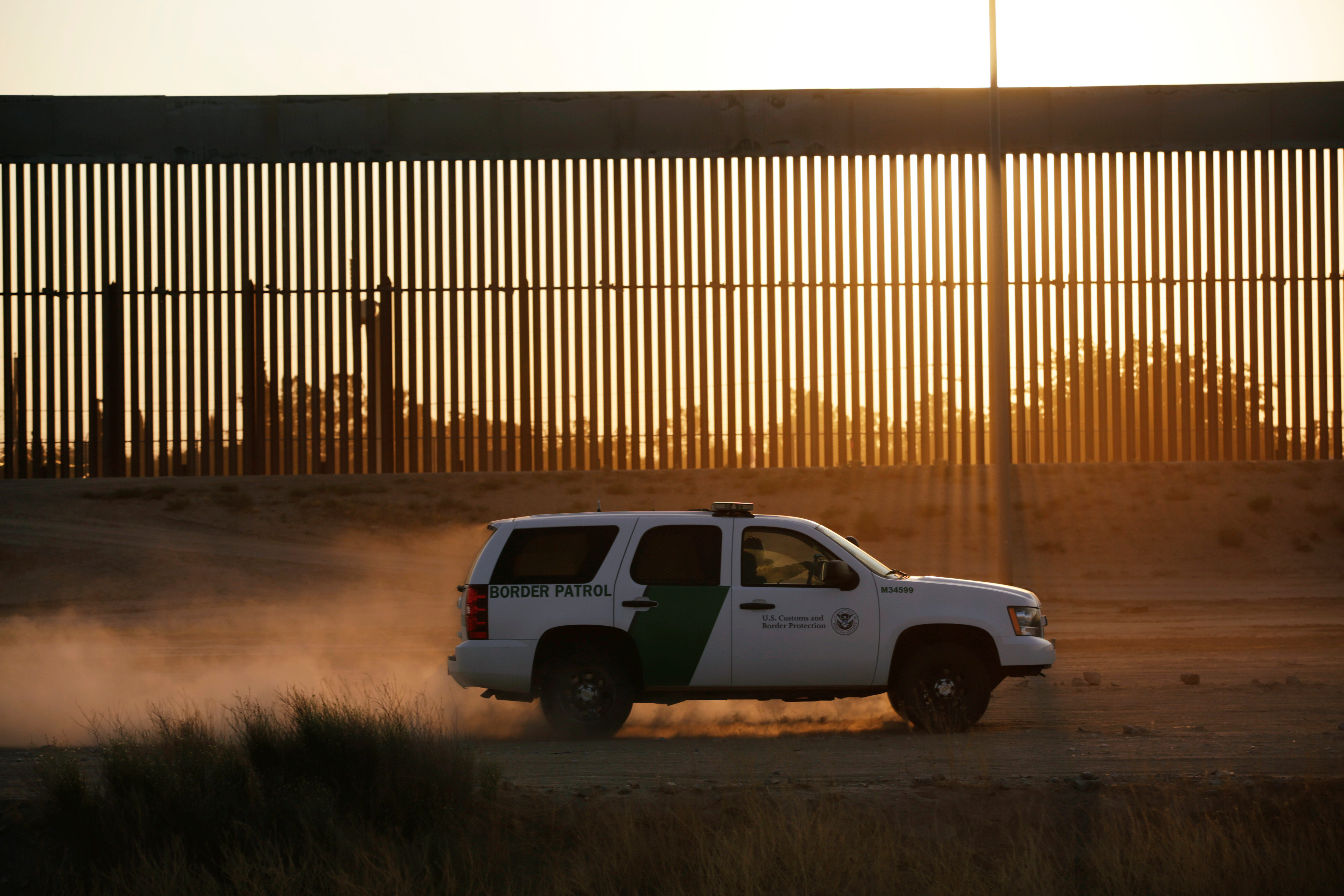 A vehicle of US Customs and Border Protection (CBP) patrols along a new section of the border wall in El Paso, Texas, as seen from Ciudad Juarez, Mexico