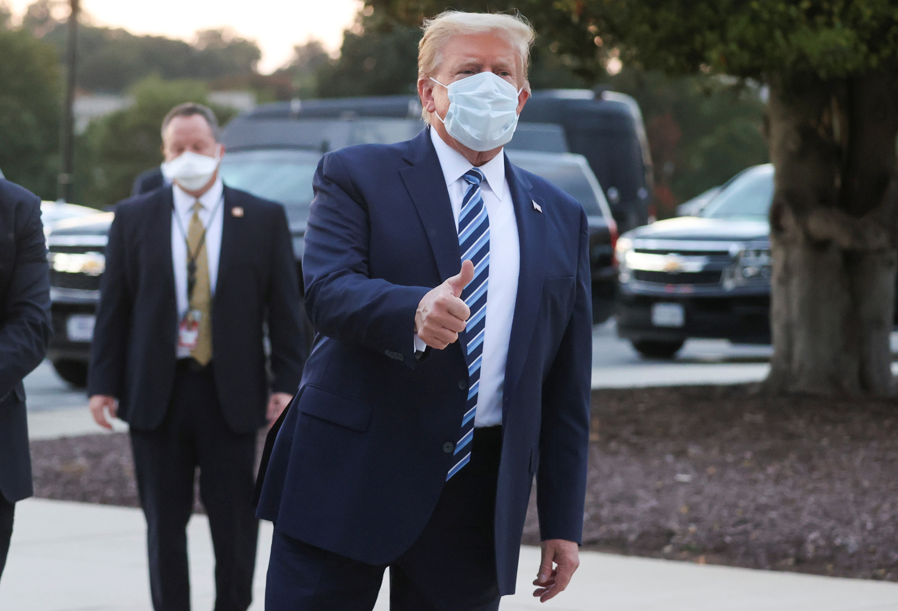 US President Donald Trump gives a thumbs up as he departs Walter Reed National Military Medical Center after a fourth day of treatment for the coronavirus disease (COVID-19) to return to the White House