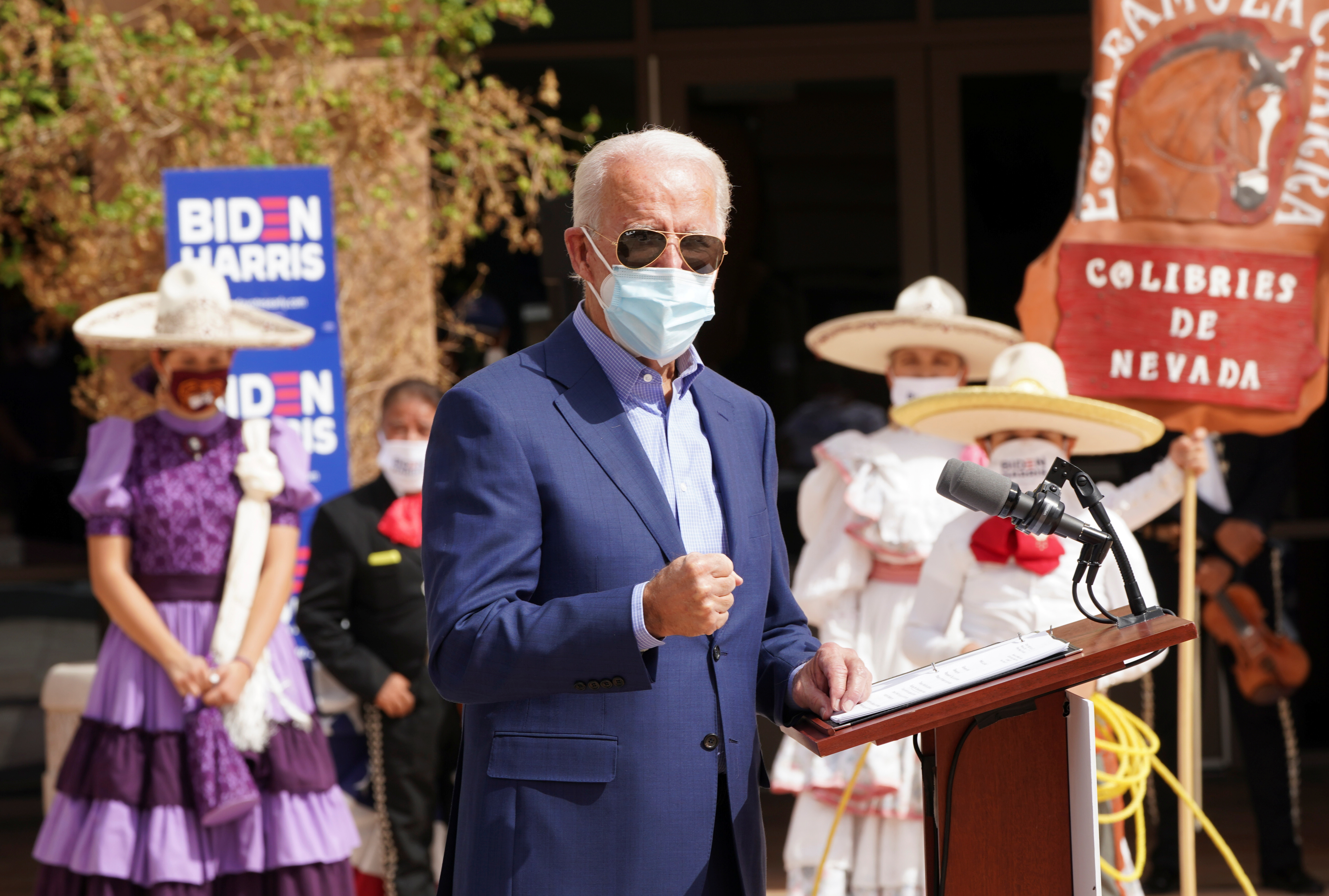 Members of a mariachi band look on as Democratic US presidential nominee Joe Biden speaks about the disproportionate ways COVID-19 has impacted Latinos in Nevada during a campaign stop at the East Las Vegas Community Center