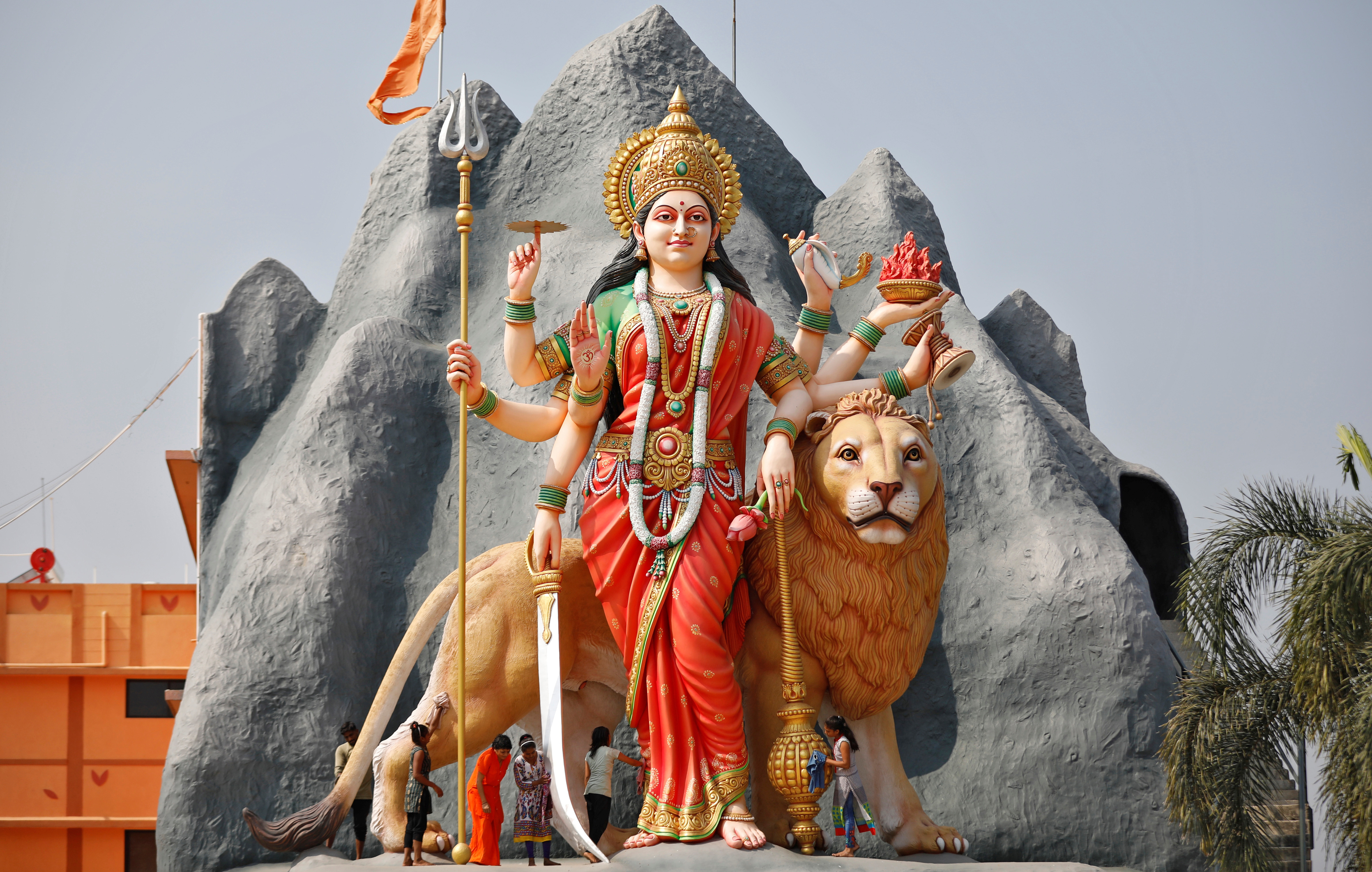 Girls clean a 34-foot tall idol of Hindu goddess Durga at a temple in Gandhinagar, Gujarat