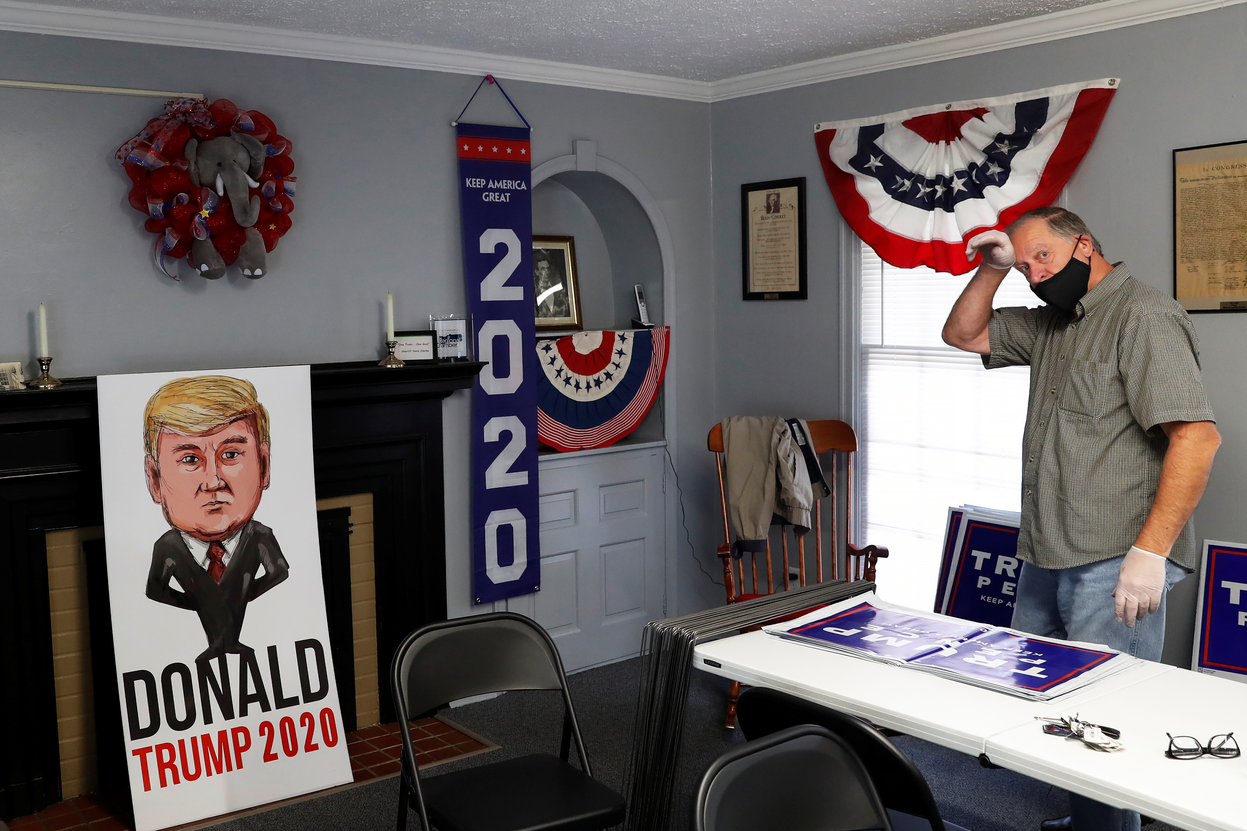 A volunteer wipes his head inside the Trumbull County Republican Party headquarters on October 1, 2020 in Warren, Ohio, the United States