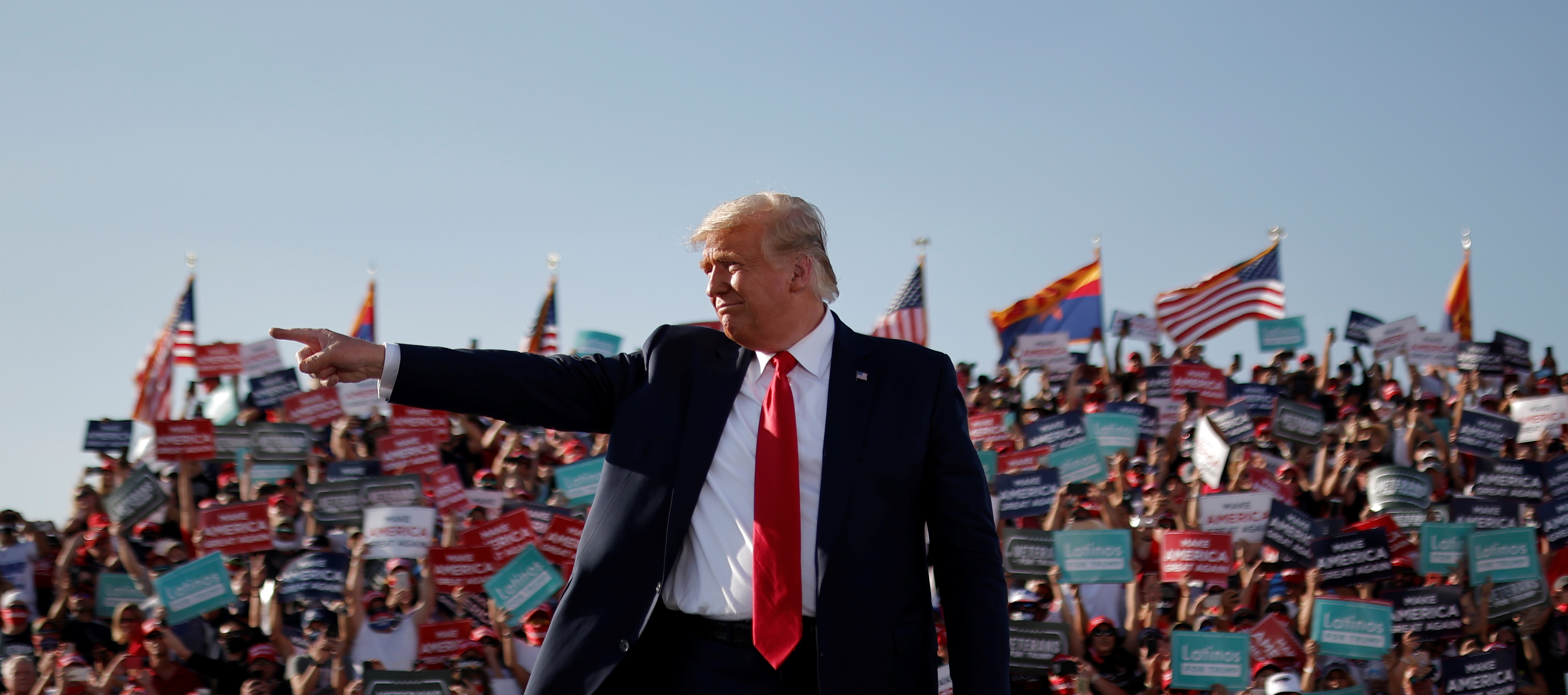 Trump gestures during a campaign rally at Tucson International Airport in Tucson, Arizona