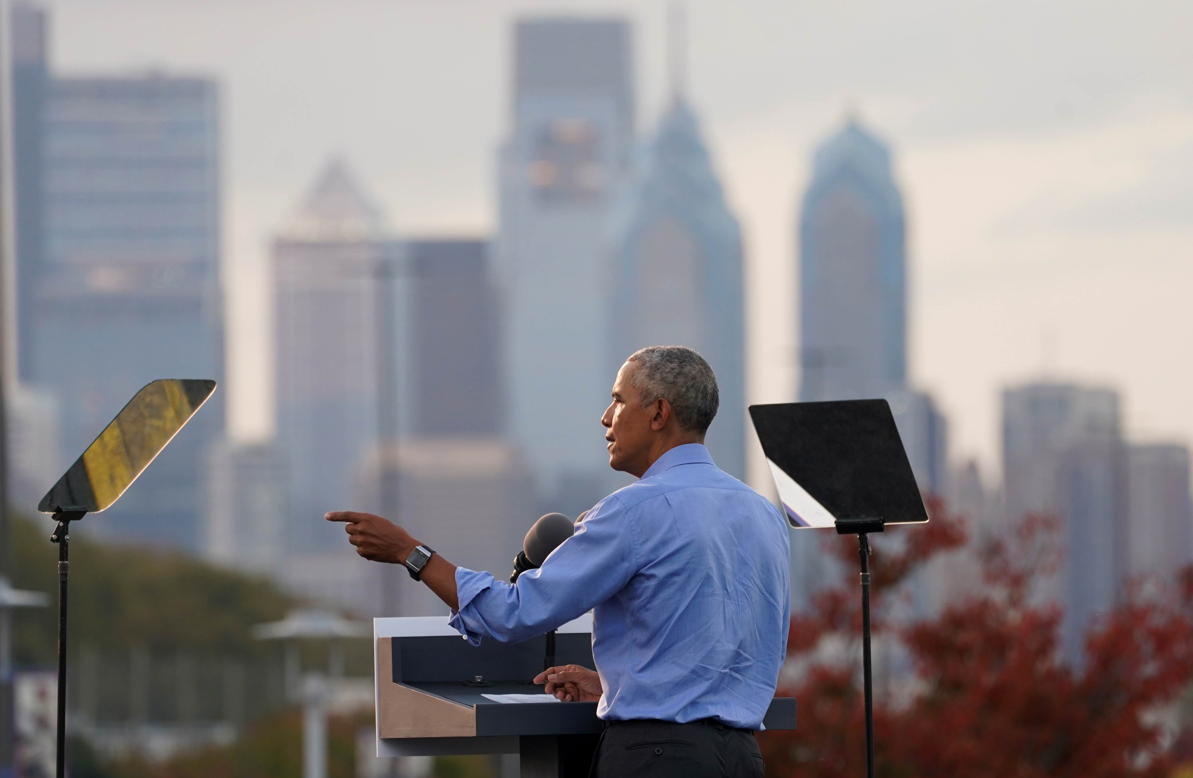 With the Philadelphia skyline before him, former President Barack Obama speaks at a drive-in campaign rally on behalf of Democratic presidential nominee and his former Vice President Joe Biden on October 21, 2020