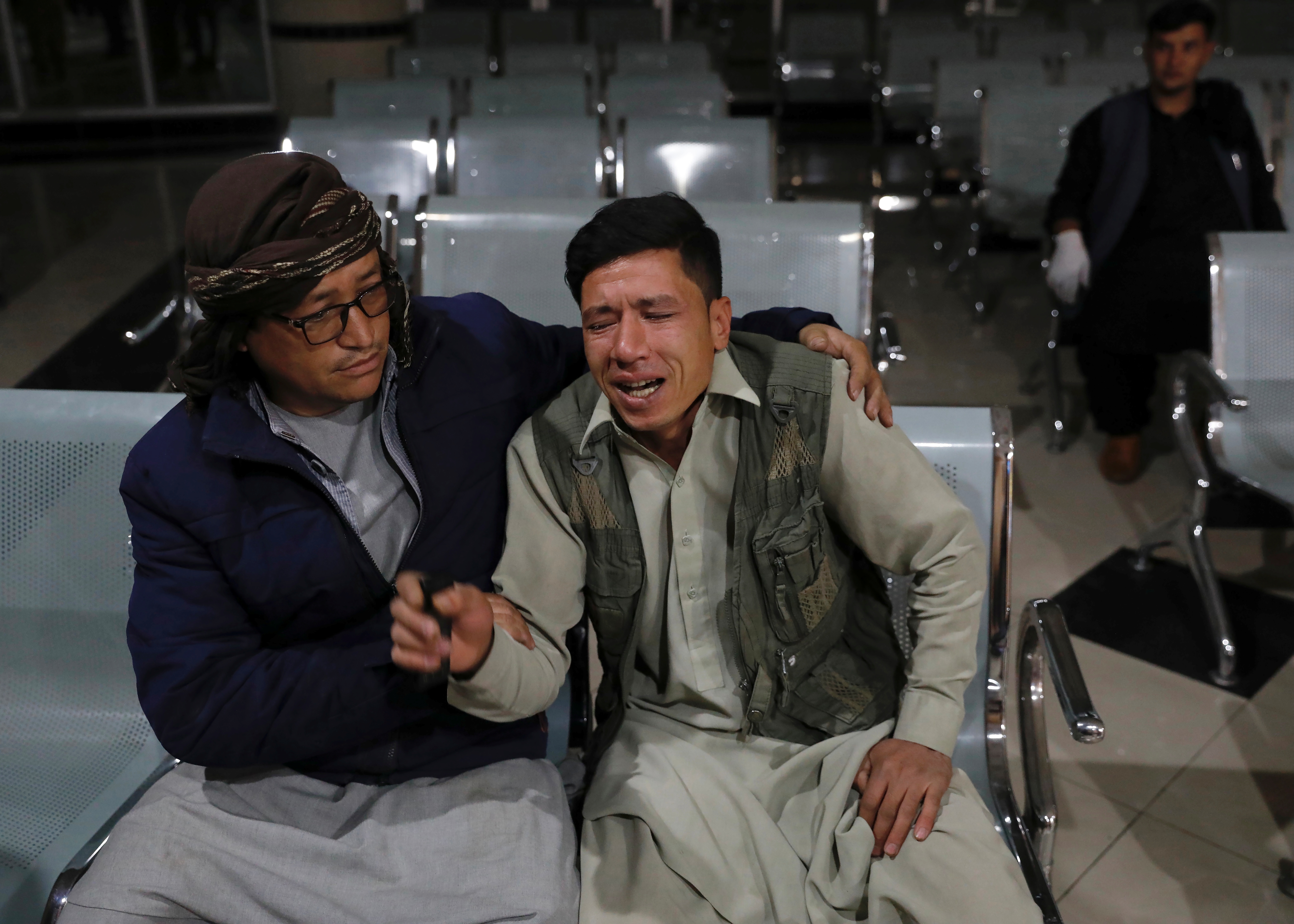 An Afghan man who lost his brother mourns at a hospital after a suicide bombing in Kabul