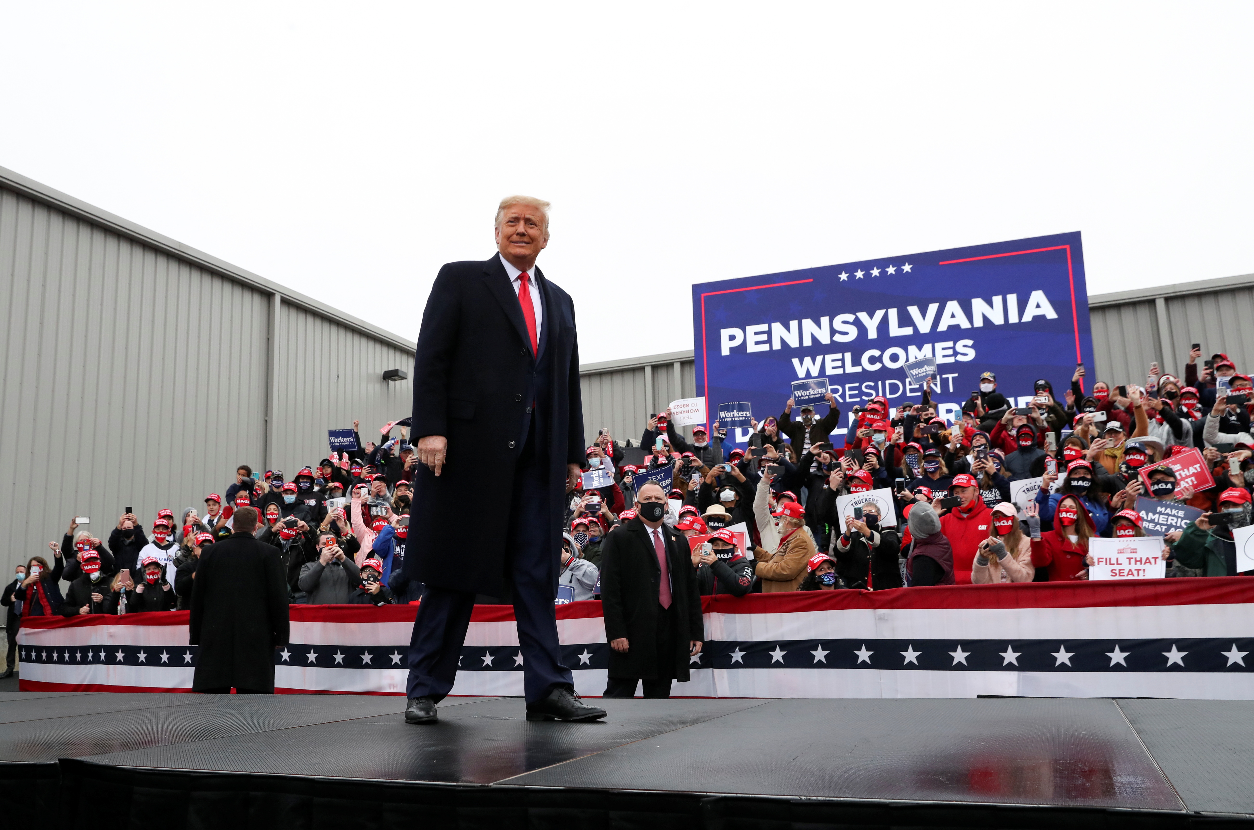 Supporters hold their cell phones as President Donald Trump arrives to hold a campaign event, in Allentown, Pennsylvania