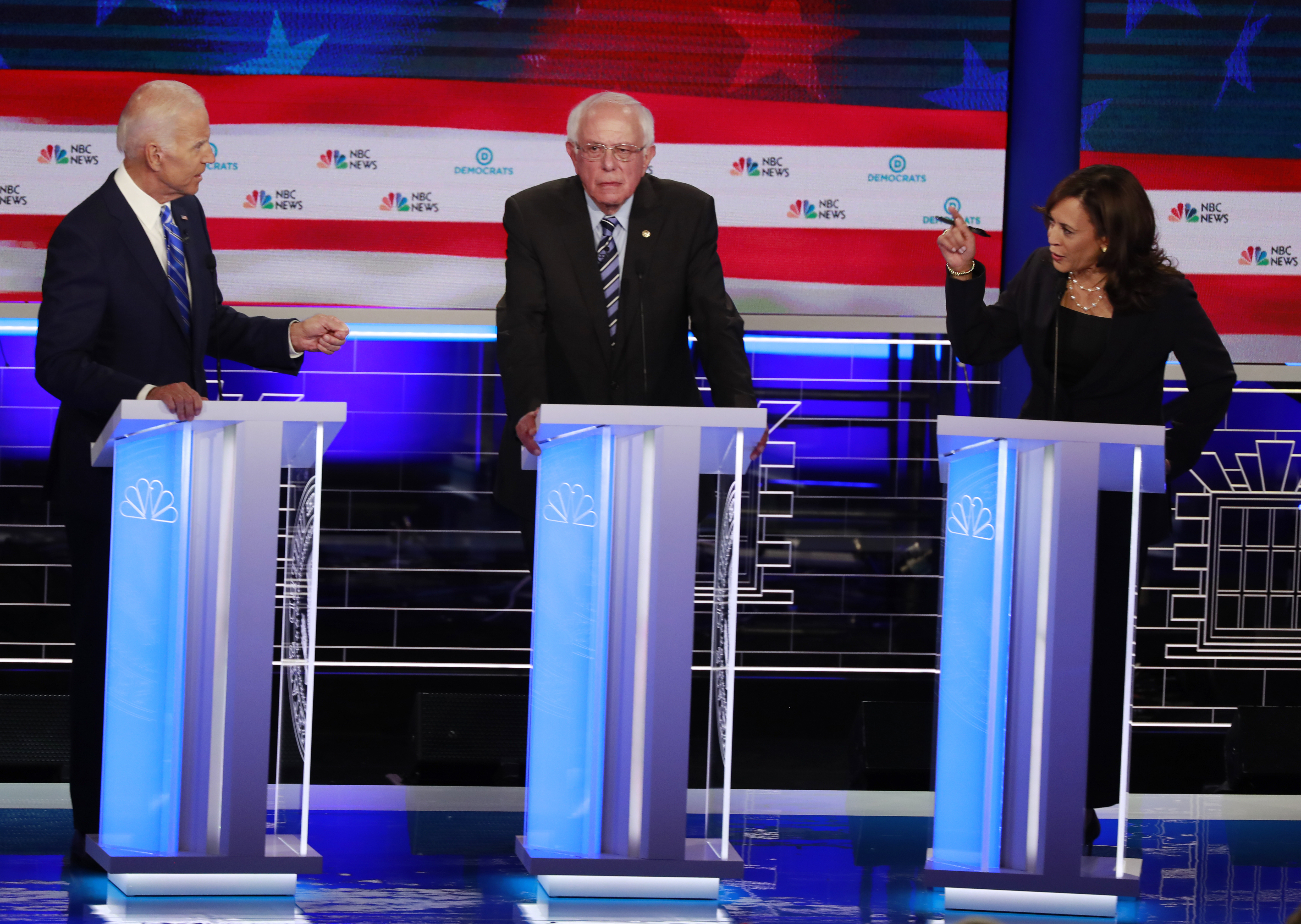 Joe Biden, left, and Kamala Harris, right, spar during a Democratic primary debate, June 27, 2019, in Miami, Florida. Senator Bernie Sanders is in the centre
