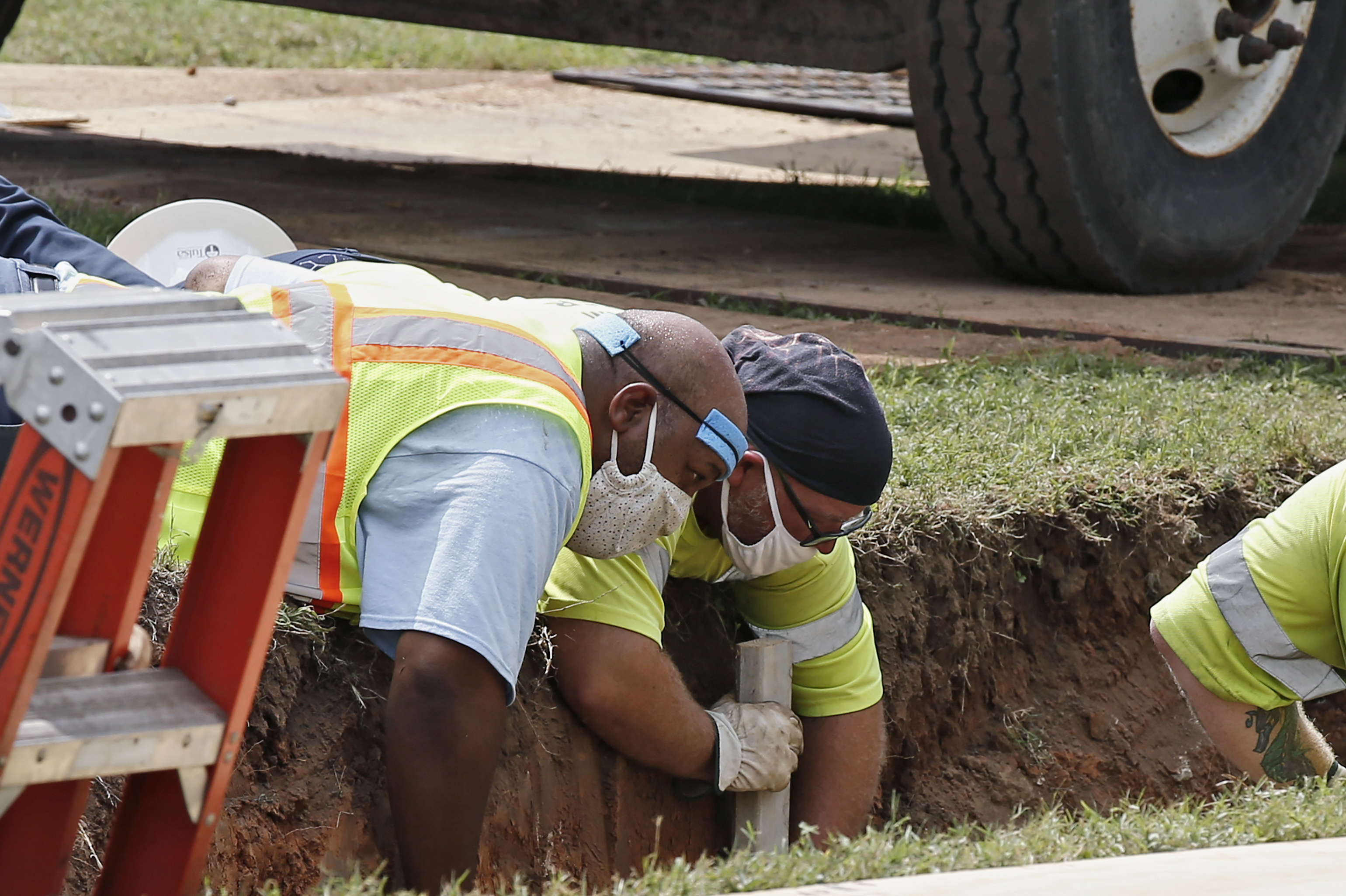 Workers reinforce the sides of an excavation site during an excavation of a potential unmarked mass grave from the Tulsa race massacre, at Oaklawn Cemetery in Tulsa in July 2020