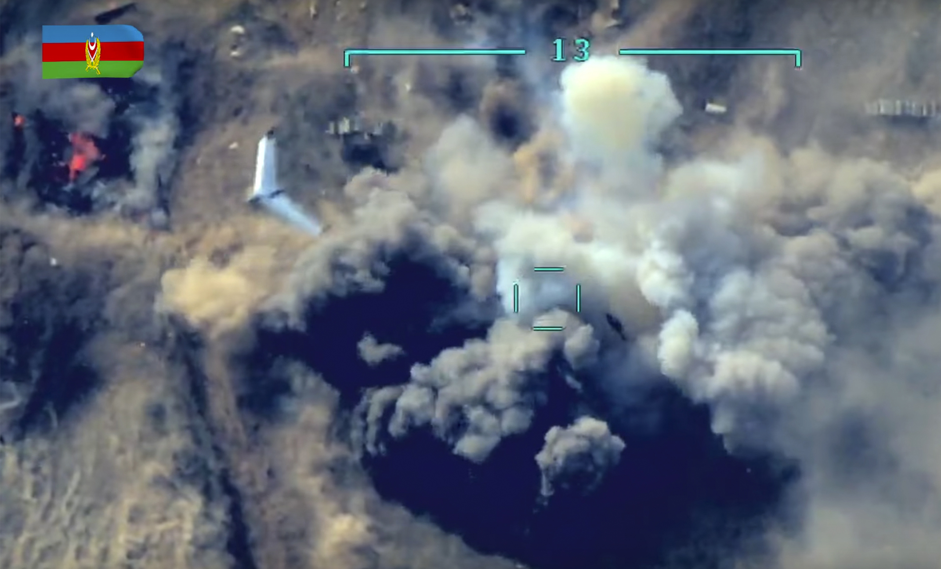 In video released by Azerbaijan’s Defense Ministry on October 1, 2020, an unmanned aerial vehicle flies over a site where Azerbaijan’s forces attack the Armenian army’s artillery during fighting in the contested Nagorno-Karabakh region [Azerbaijan Defense Ministry via AP]