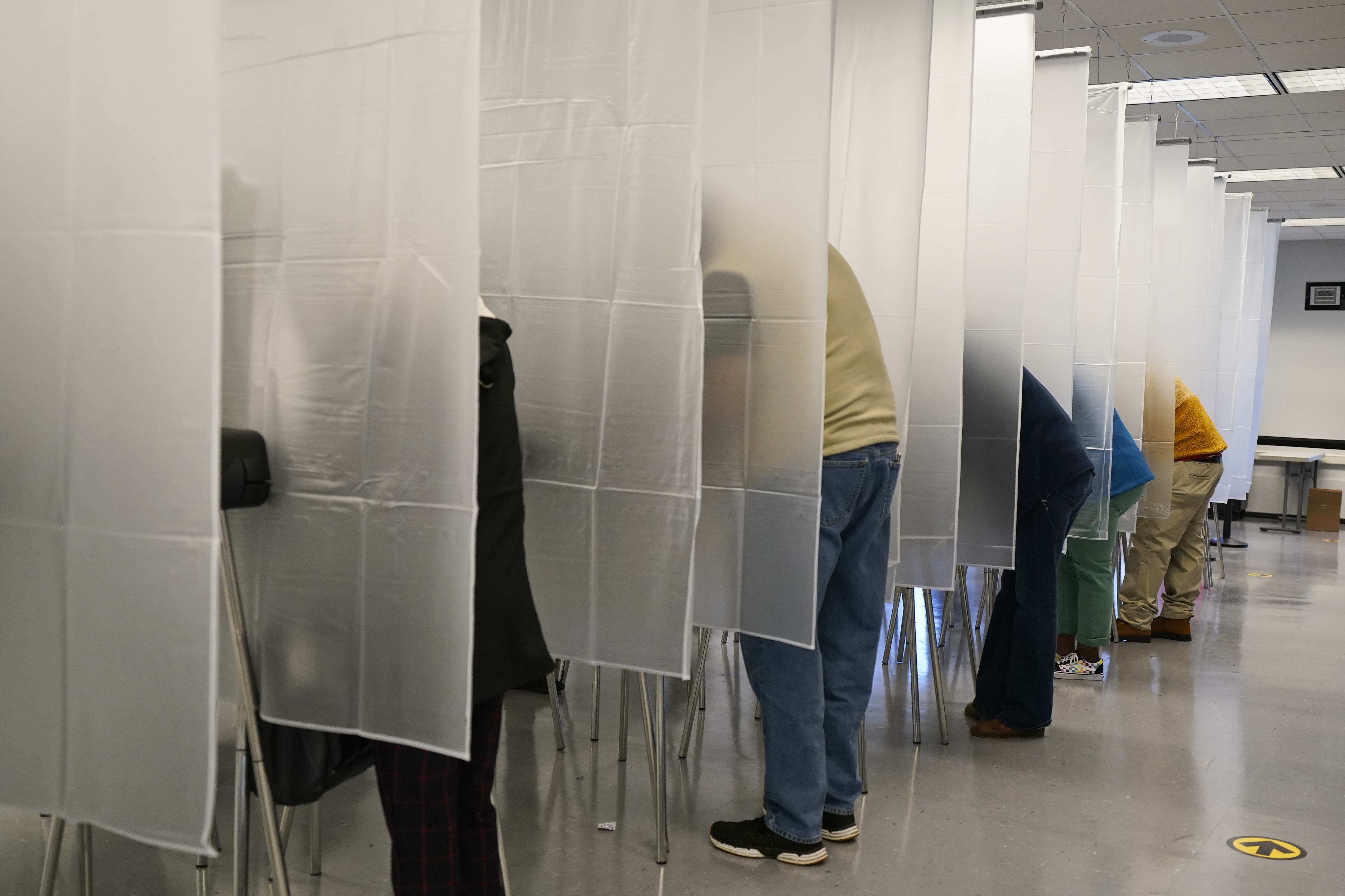 Voters fill out their ballot during early voting at the Cuyahoga County Board of Elections on October 6, 2020, in Cleveland, Ohio