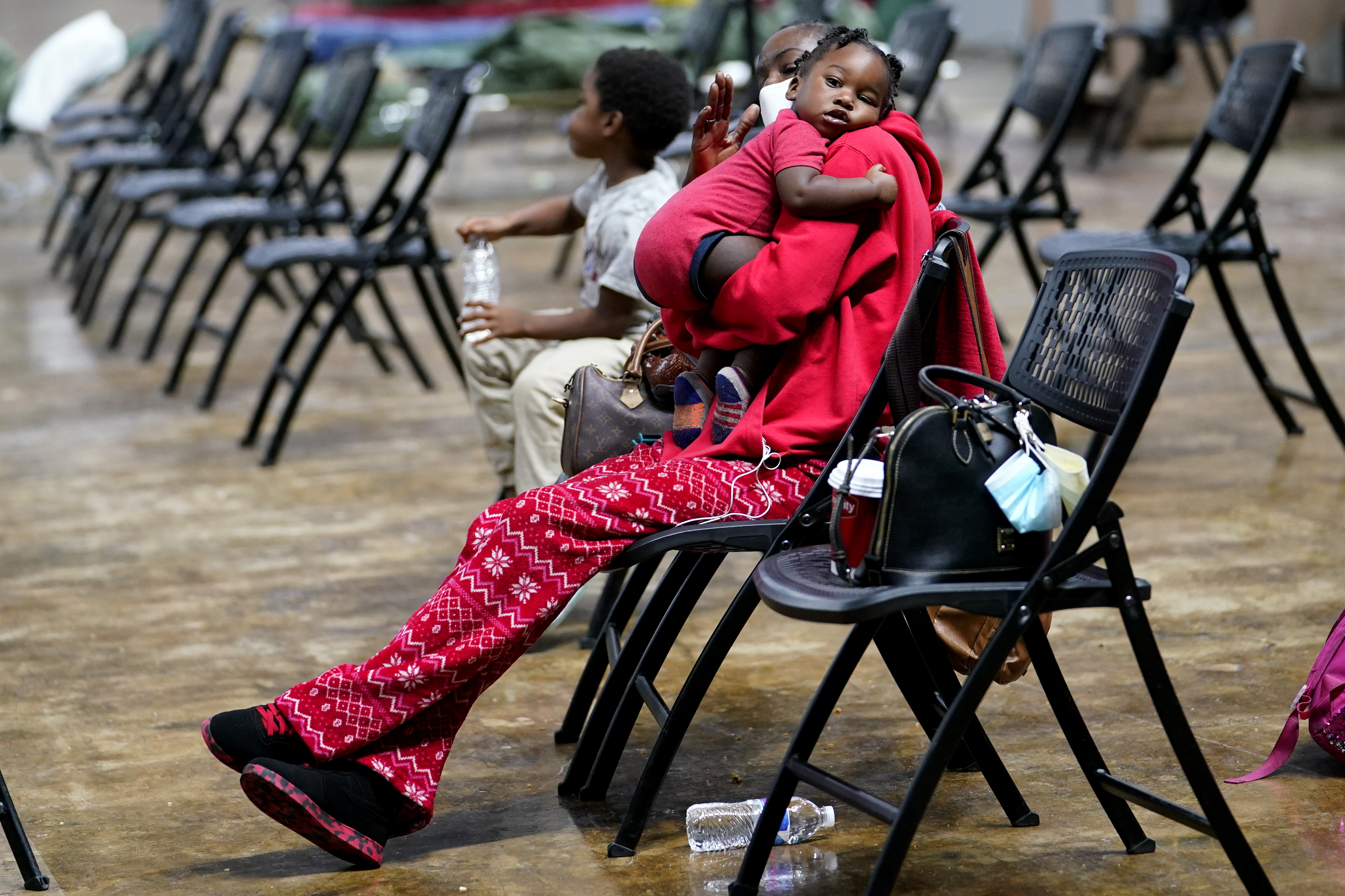 Roslyn Kennedy holds one-year-old Malaka Kennedy in a shelter in Lake Charles, Louisiana, ahead of Hurricane Delta