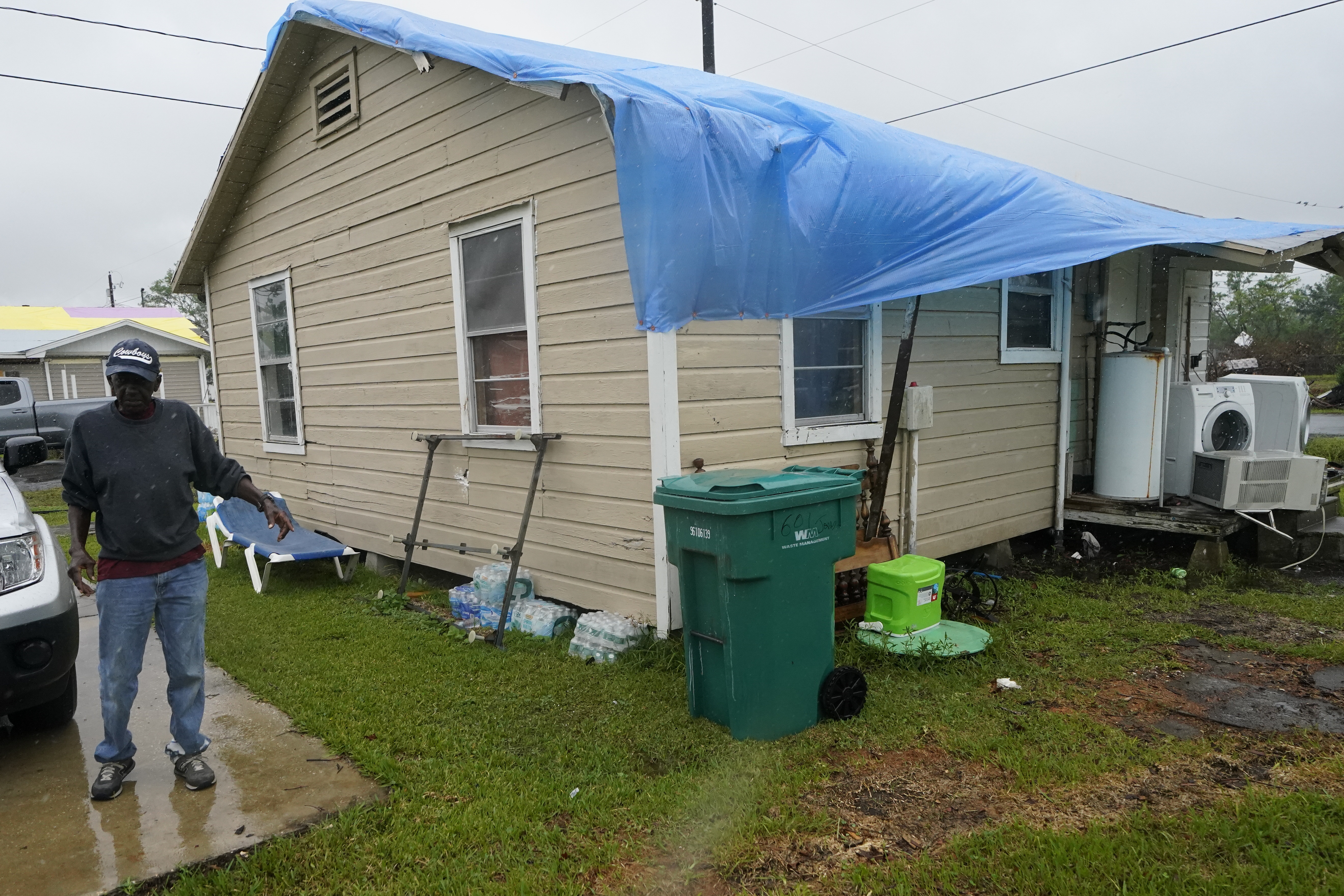 Earnst Jack standing near his home, which was damaged by Hurricane Laura
