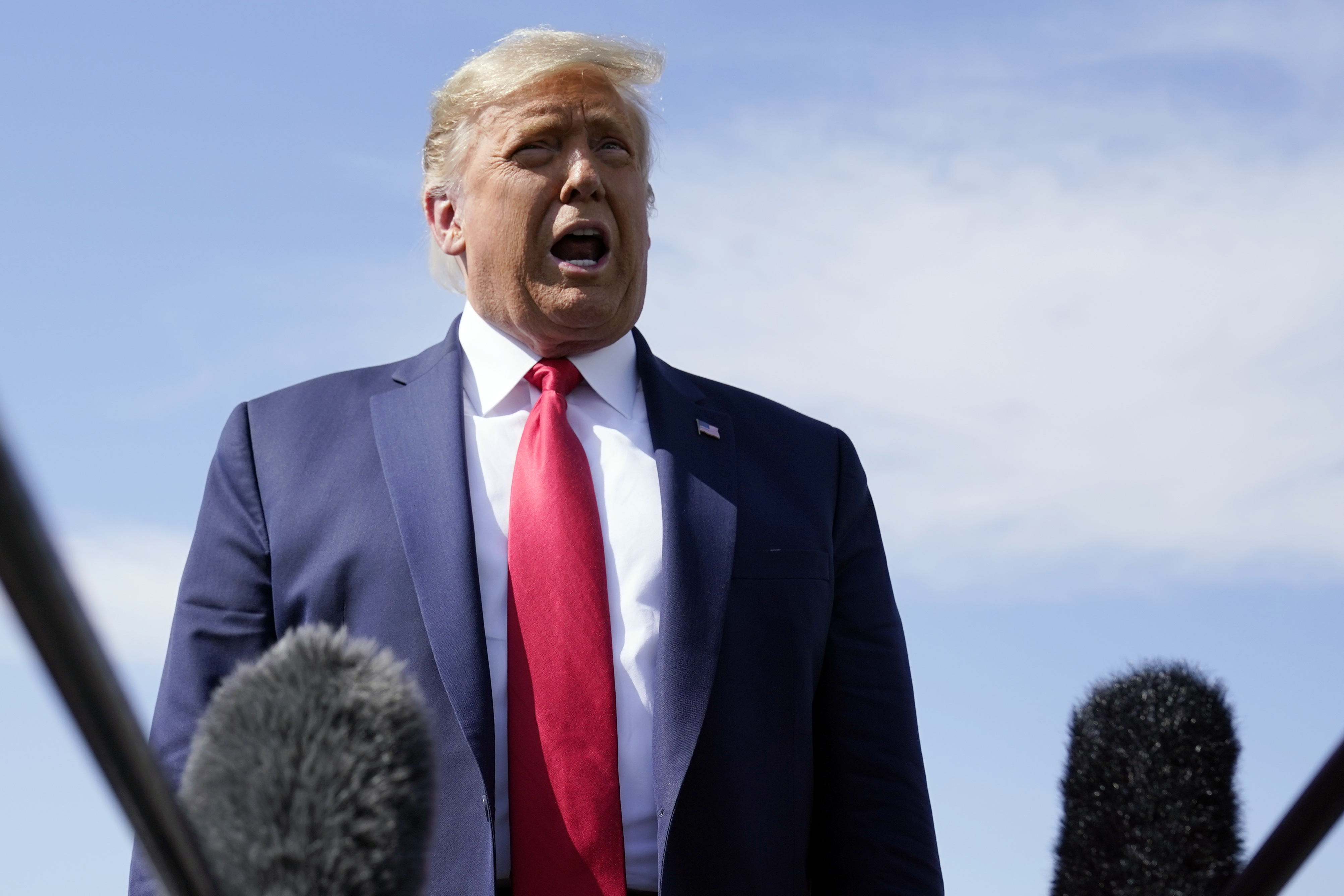 President Donald Trump talks to reporters at Phoenix Sky Harbor International Airport