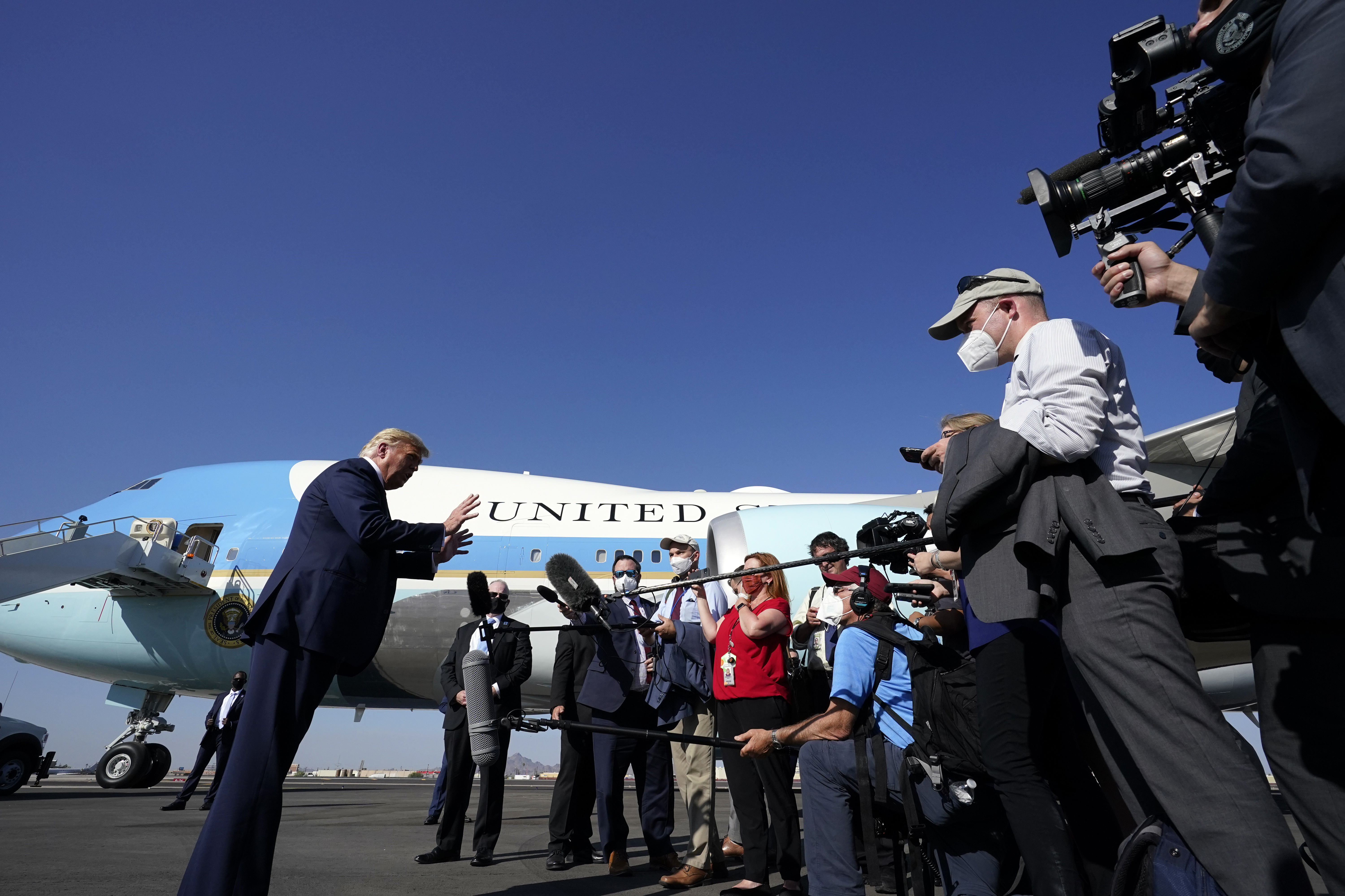 President Donald Trump speaks to reporters at Phoenix Sky Harbor International Airport while campaigning in Arizona on Monday, October 19, 2020