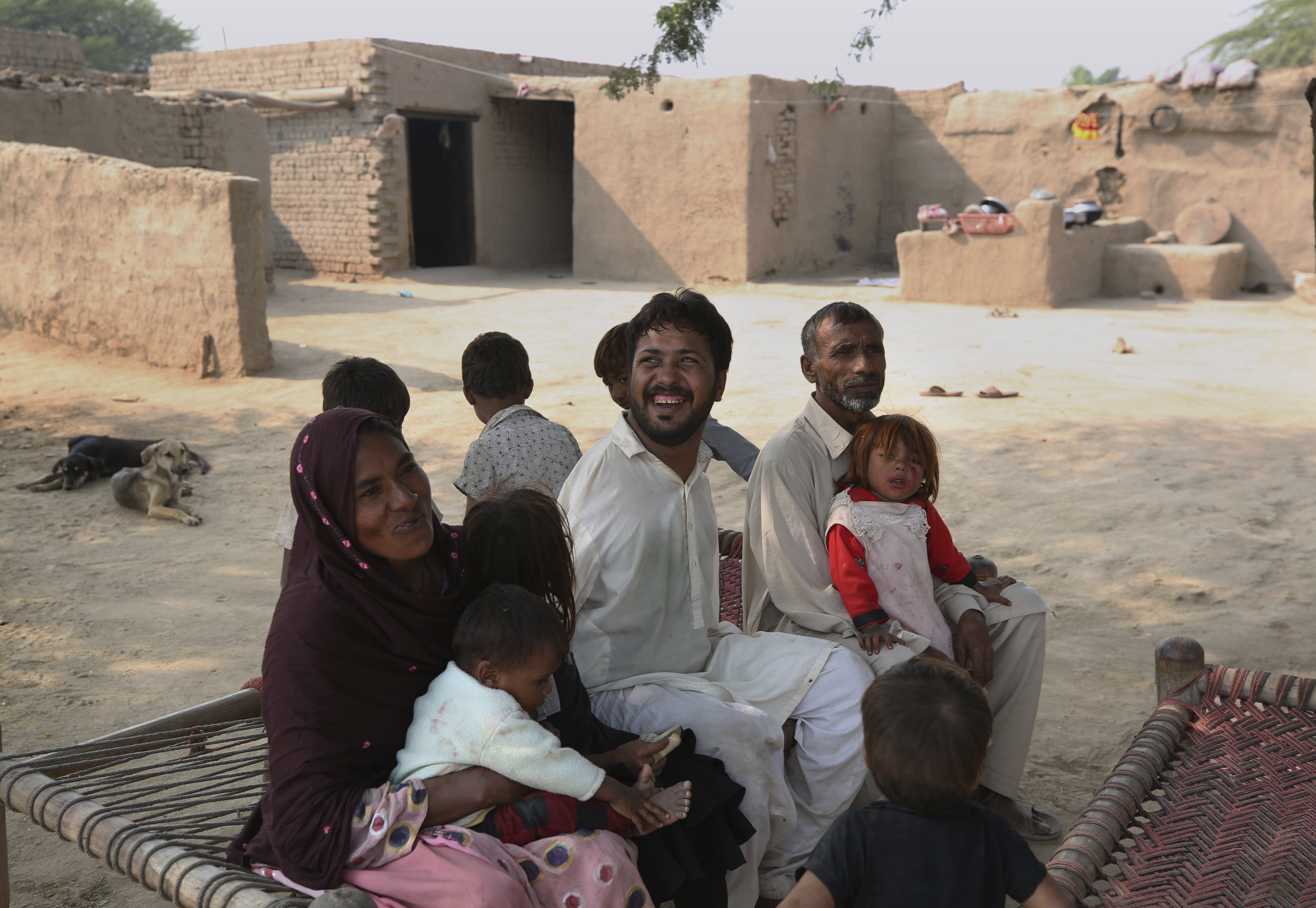 Ikram with his family at their home in a village near Samundri, Pakistan