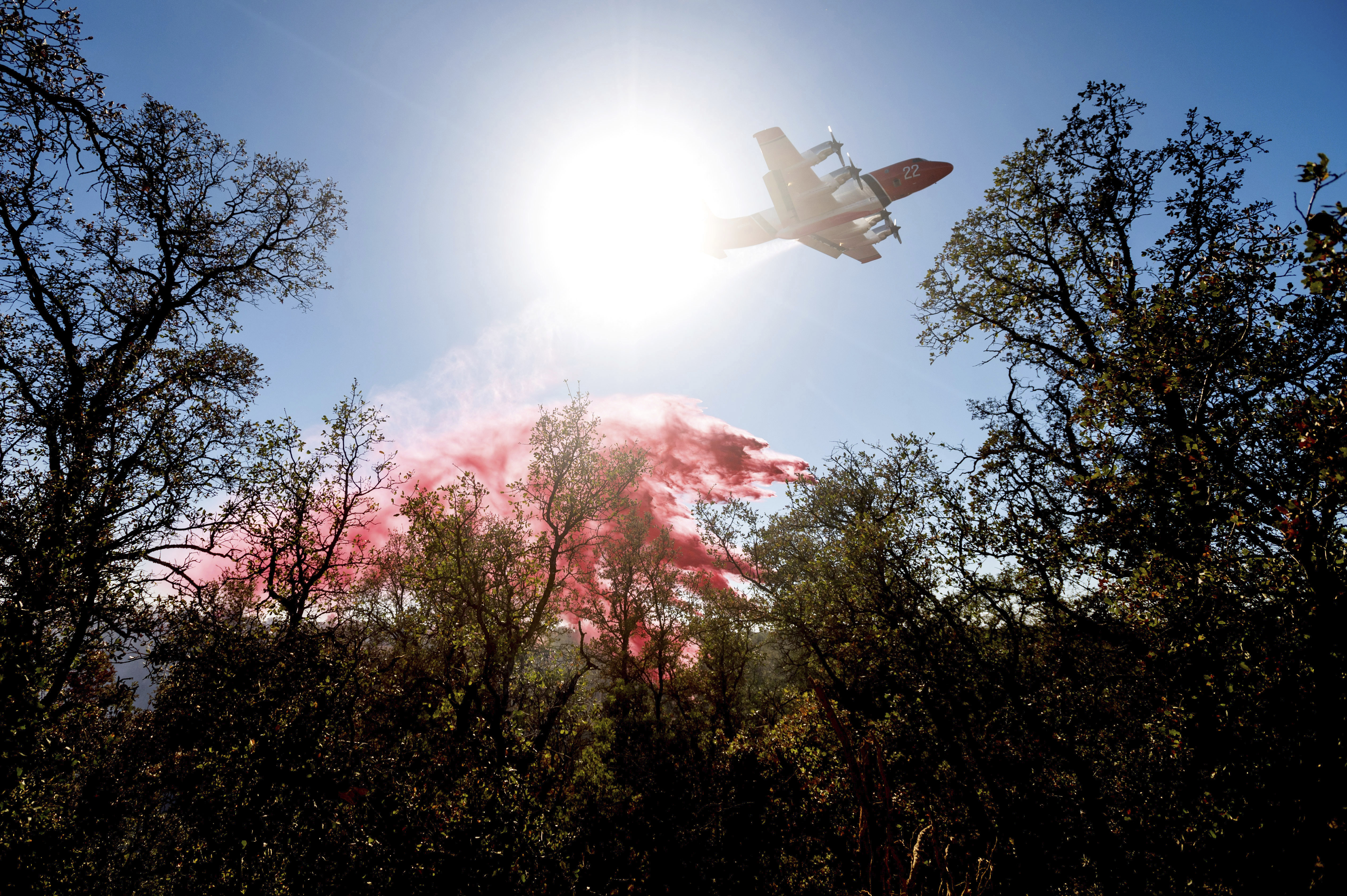 An air tanker drops retardant on the Olinda Fire in Anderson, California October 25, 2020. The blaze was one of four fires burning near Redding that firefighters scrambled to stop as high winds buffeted Northern California