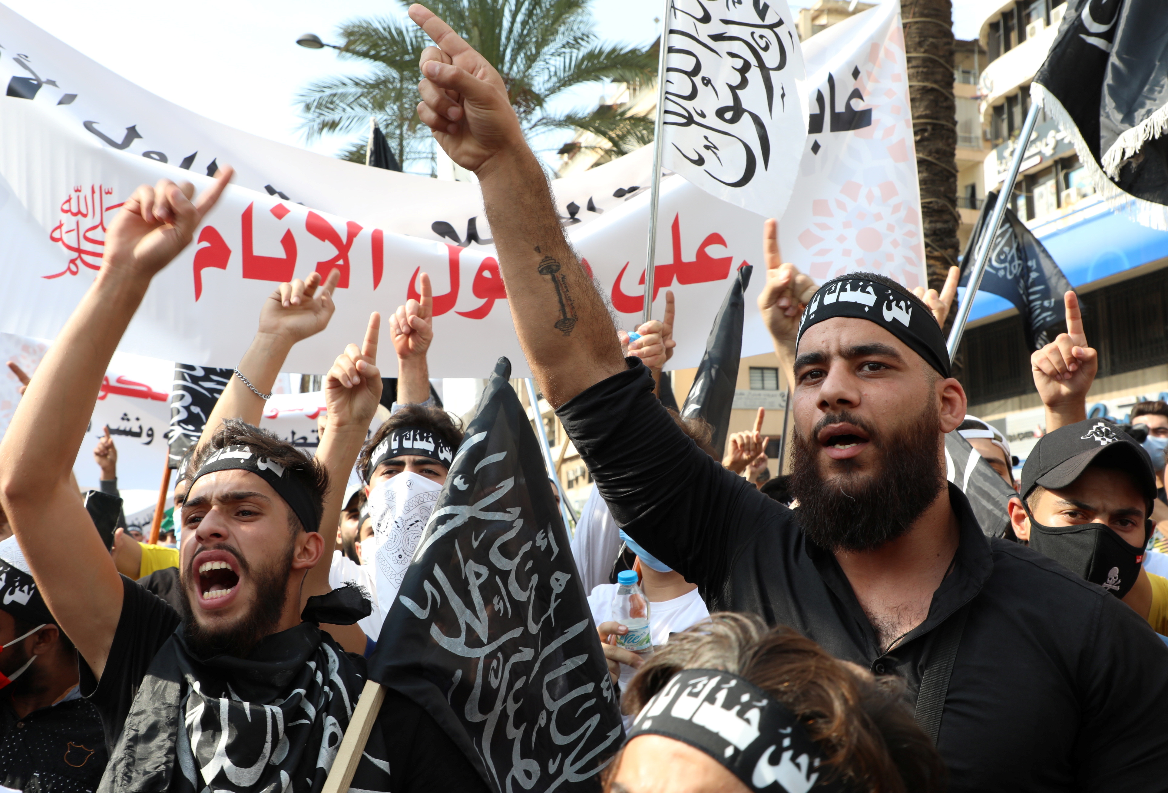 Demonstrators gesture during a protest against the cartoon publications of Prophet Muhammad in France in Beirut [Reuters]