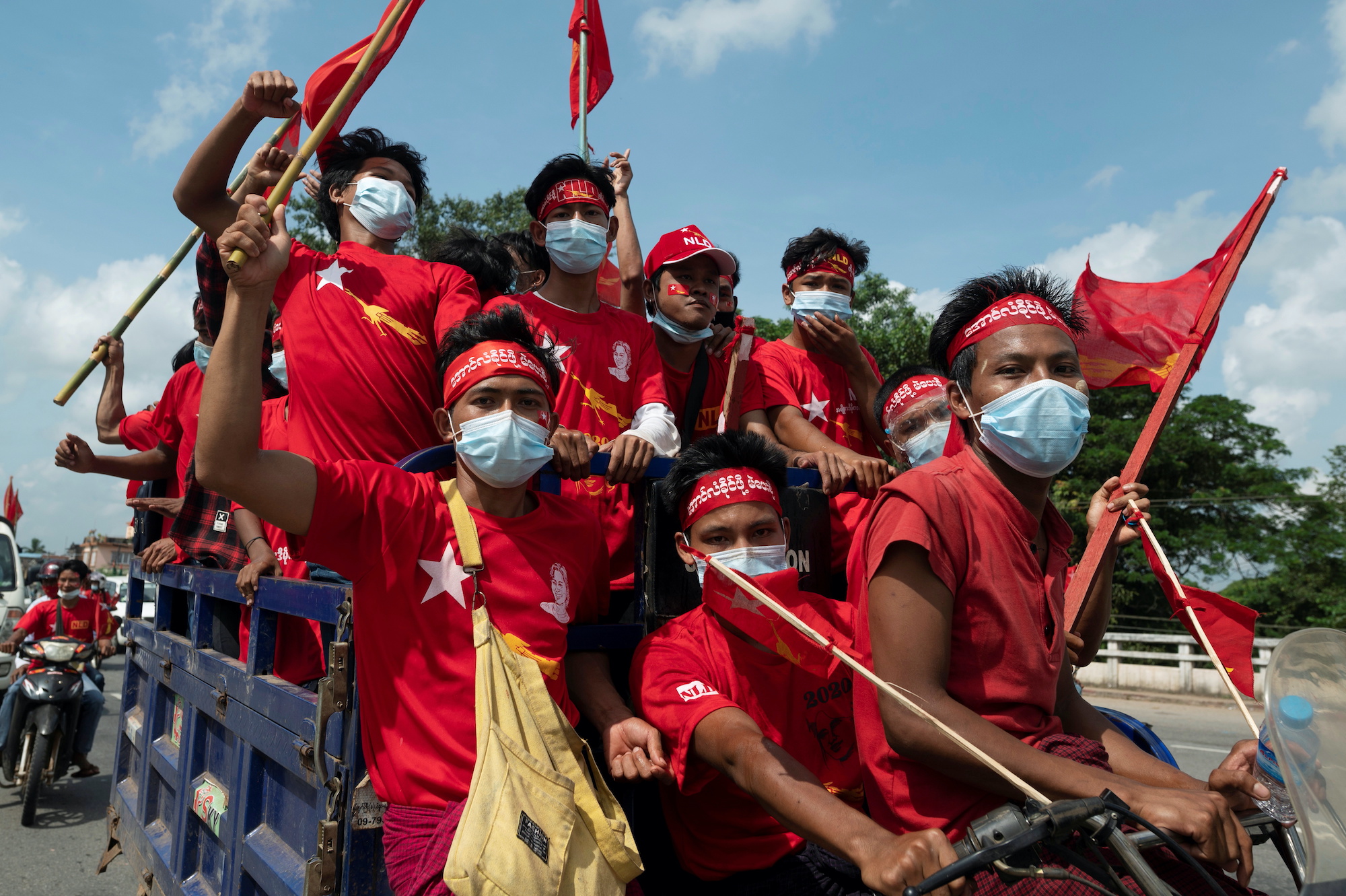 Supporters of the governing National League for Democracy (NLD) party take part in a campaign rally ahead of a November 8 general election, in the outskirts of Yangon, Myanmar, October 25, 2020 [Shwe Paw Mya Tin/Reuters]