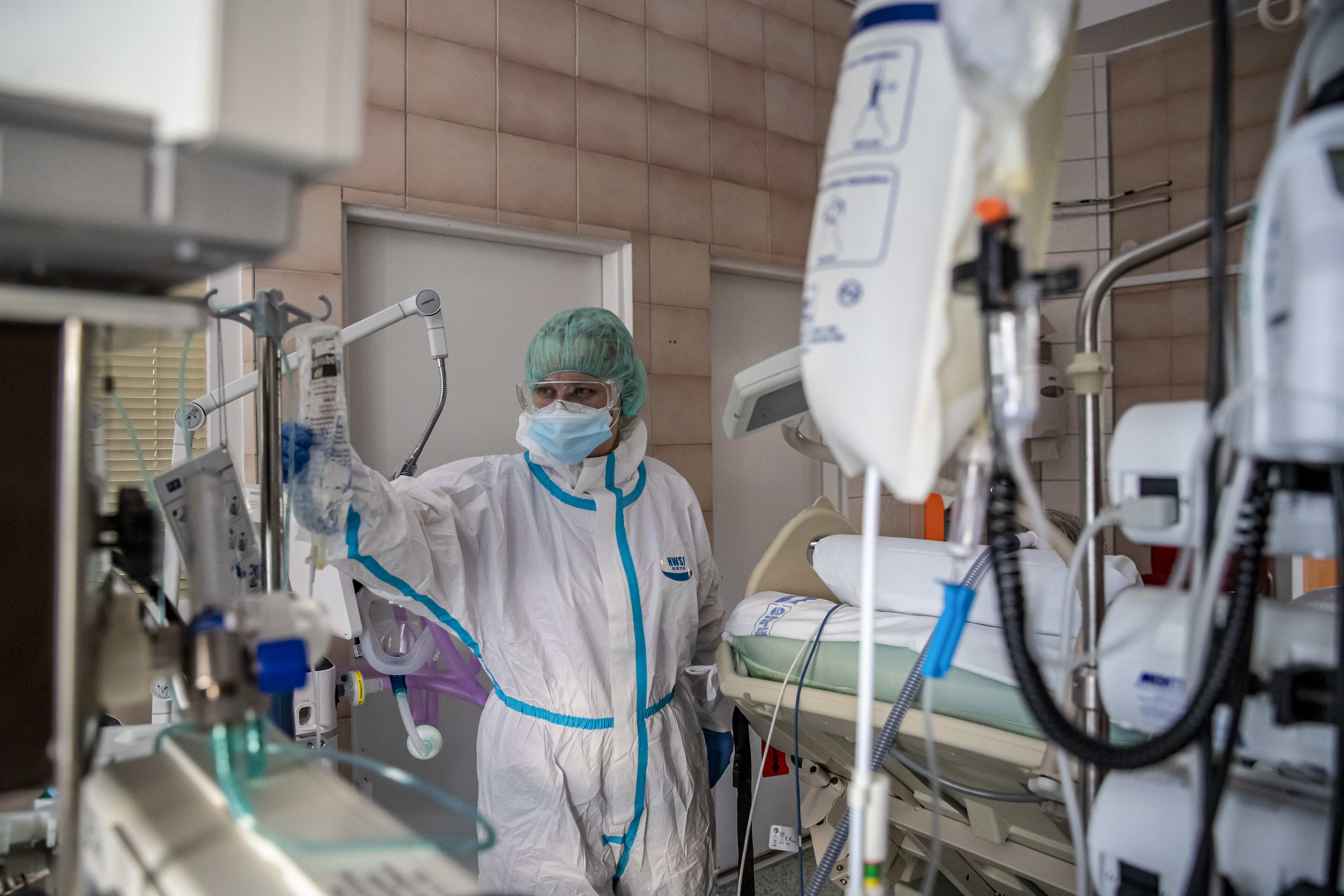 A healthcare worker cares for a COVID-19 patient in an ICU at Na Bulovce hospital in Prague, Czech Republic
