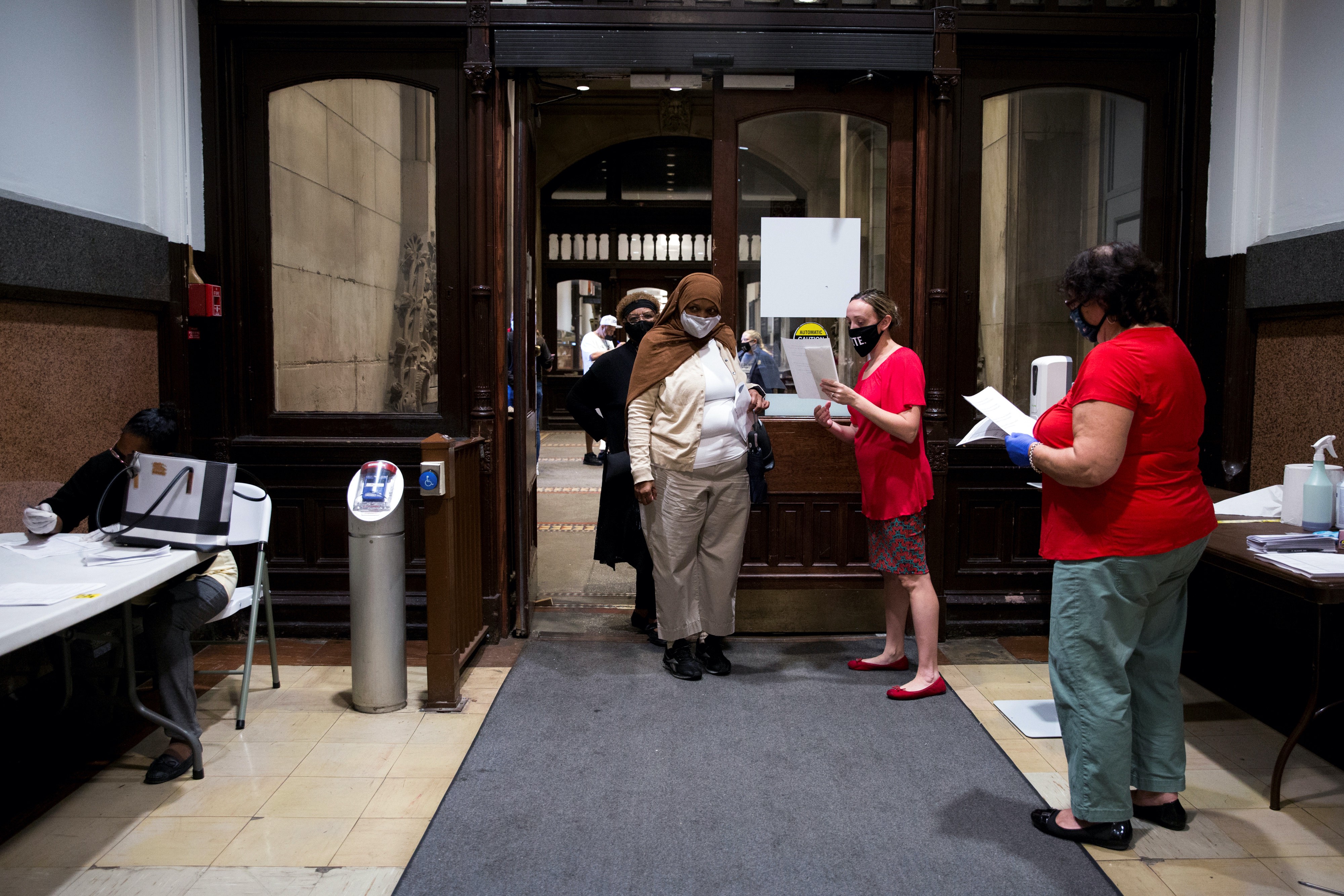 Voters line up to vote early in the 2020 President Election at a satellite voting location at City Hall in Philadelphia, Pennsylvania, United States
