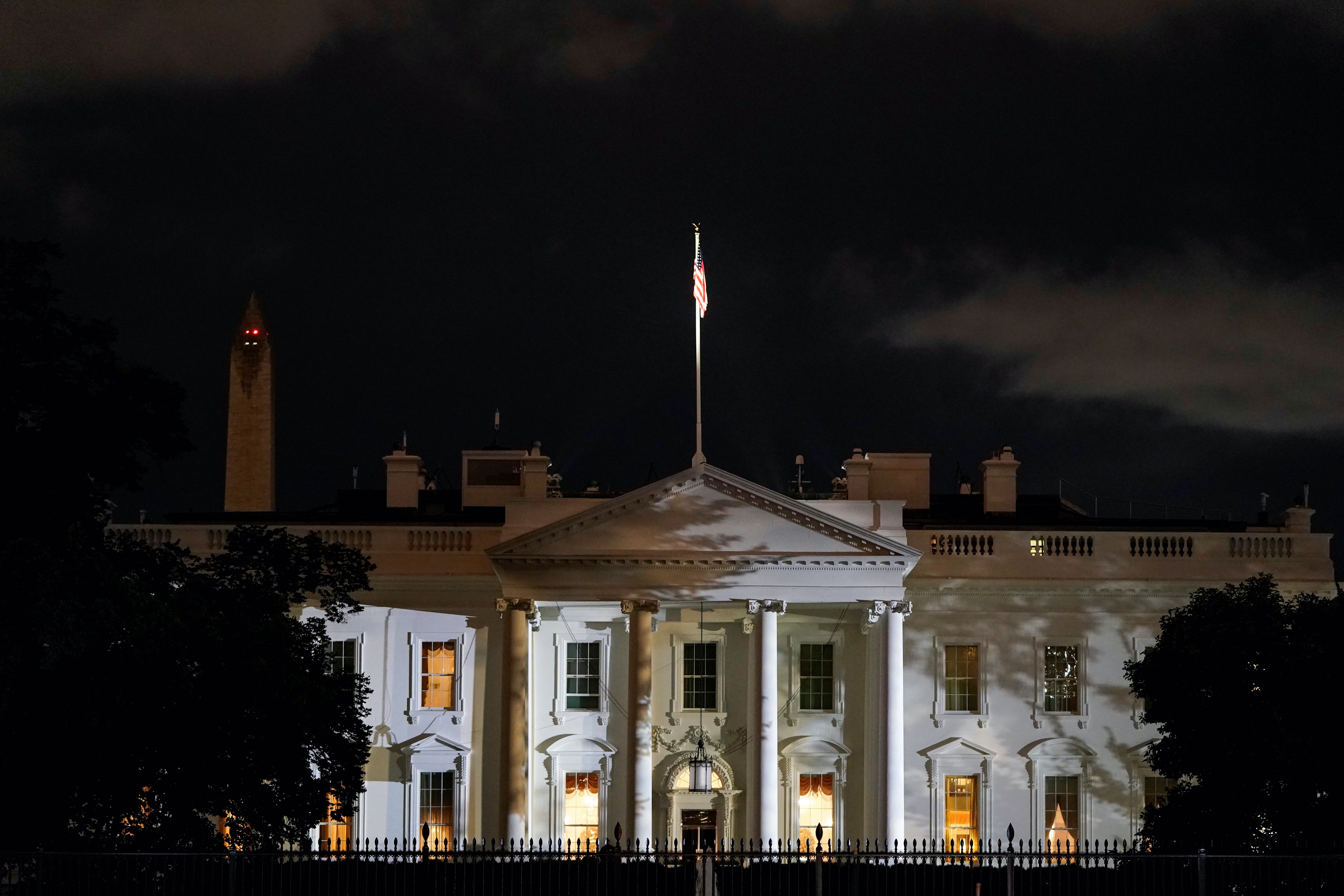The White House is lit before dawn after United States President Donald Trump announced that he and first lady Melania Trump both tested positive for the coronavirus