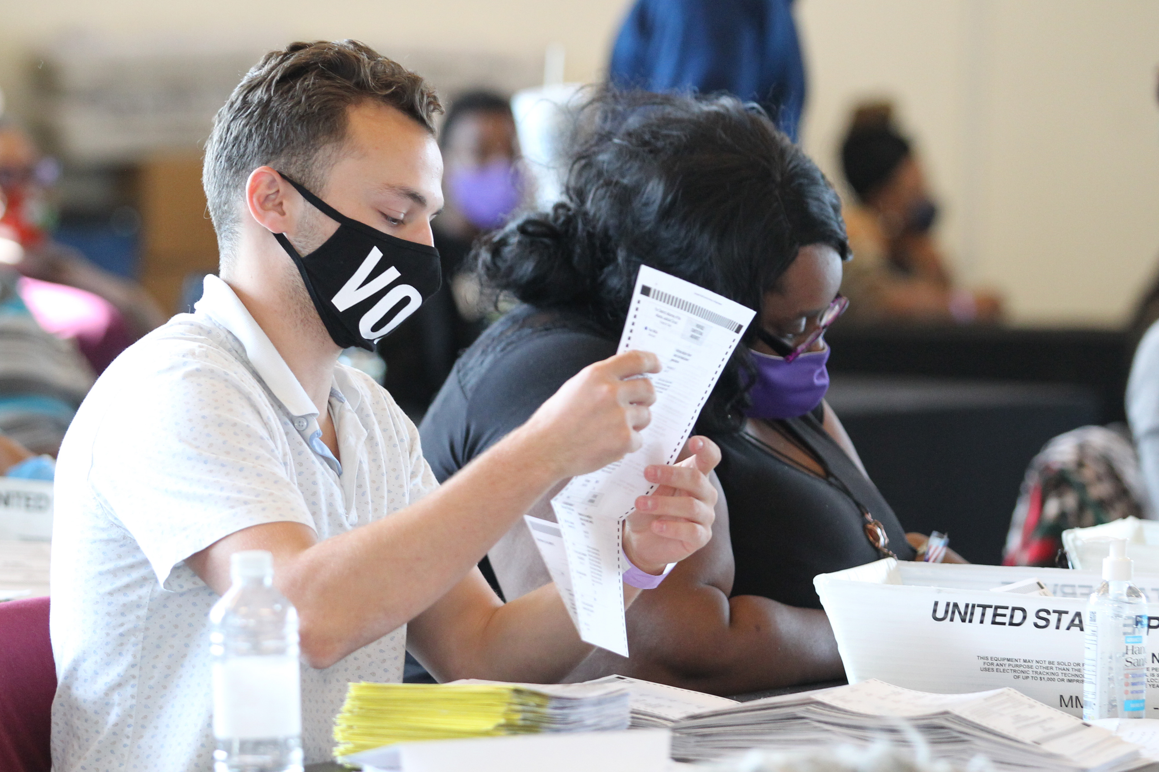 Fulton County election workers examine ballots while vote counting, at State Farm Arena on November 5, 2020, in Atlanta, Georgia, US