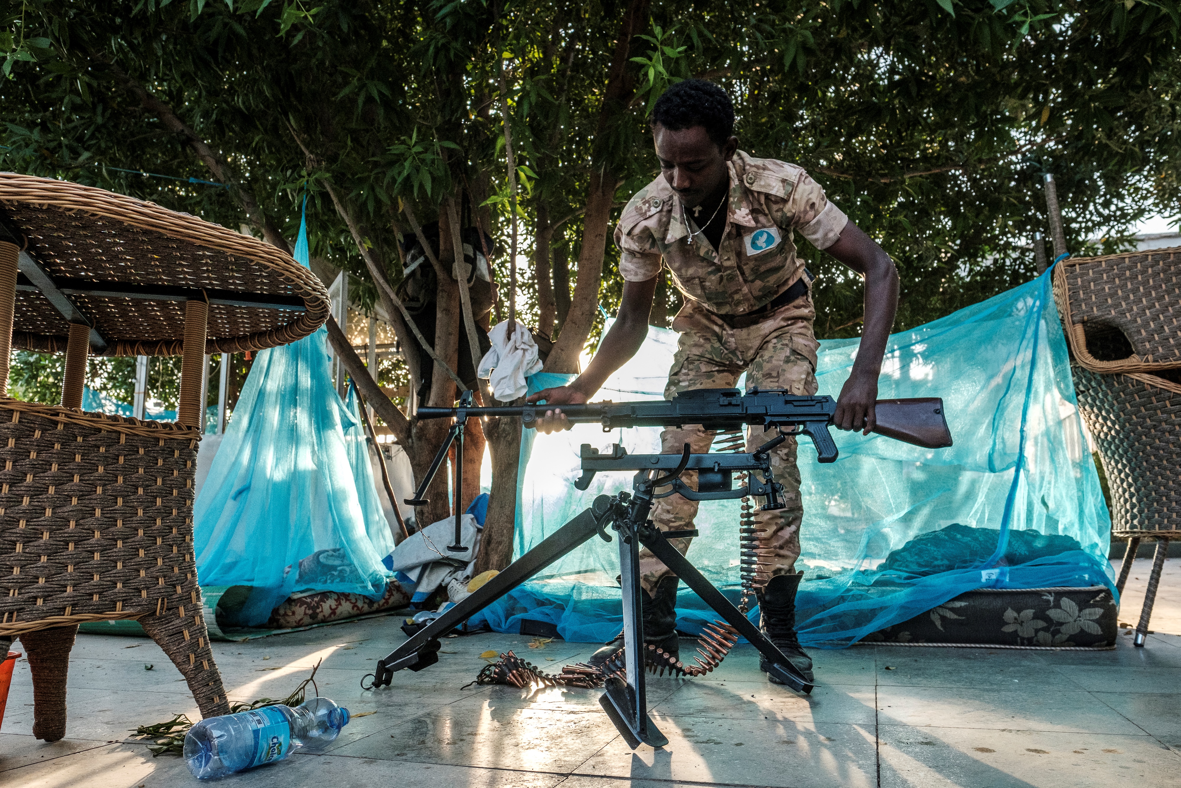 A member of neighbouring Amhara state’s special forces mounts a machine gun at an improvised camp in front of a shop in Humera, Ethiopia