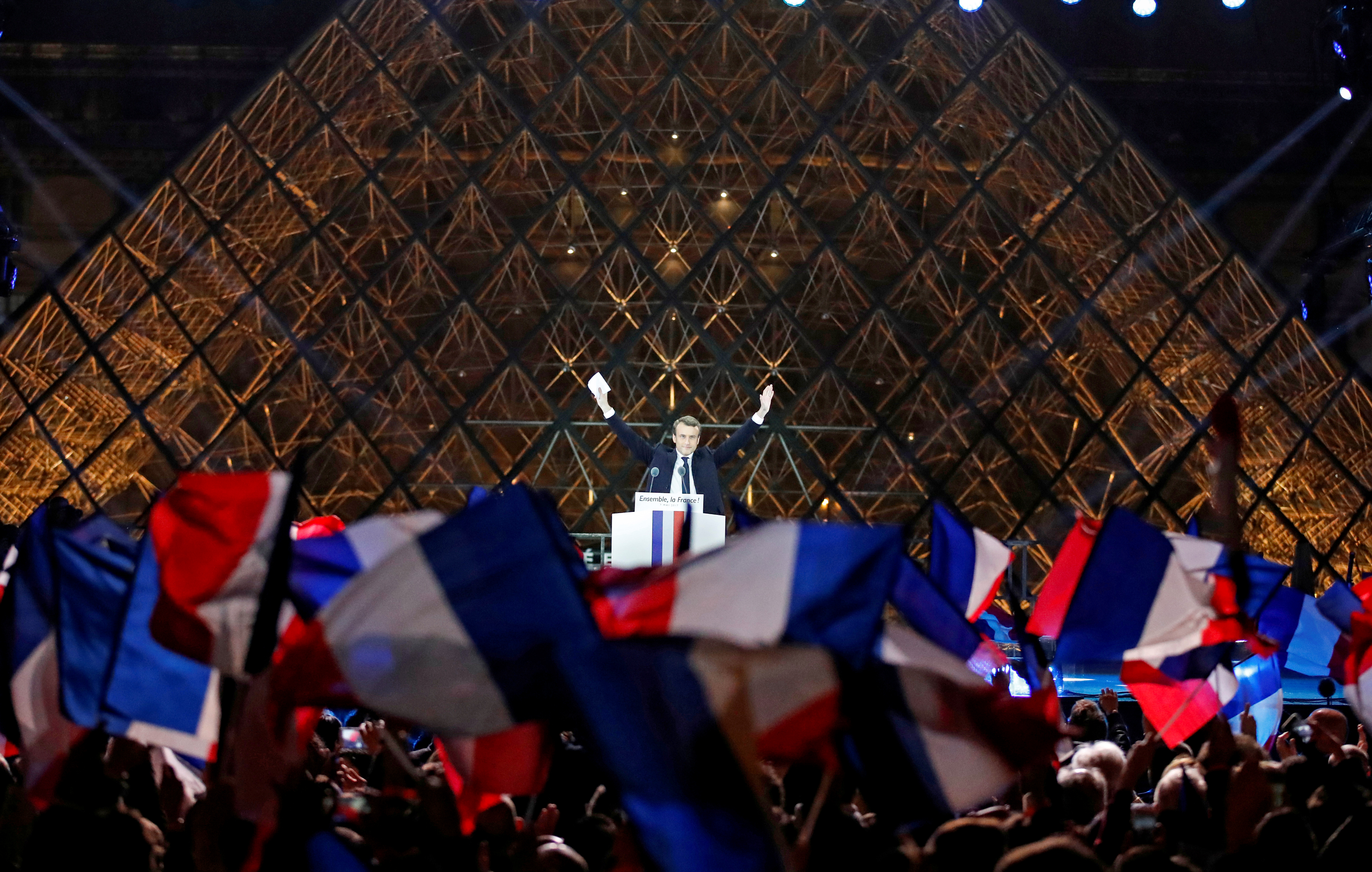 Macron celebrates on the stage at his victory rally near the Louvre in Paris, France May 7, 2017