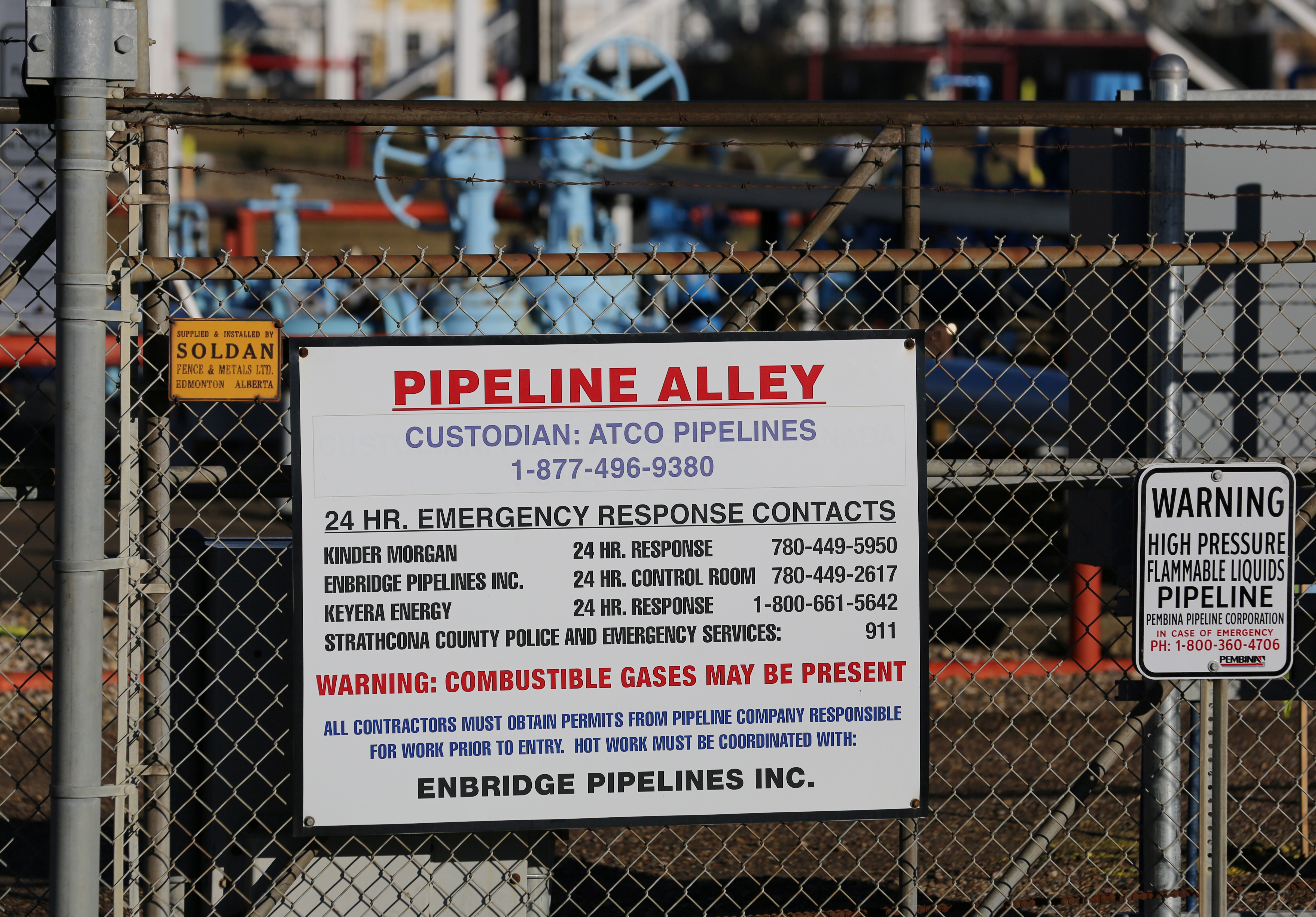 A sign listing emergency contacts for the companies on ‘Pipeline Alley’ (Enbridge, Kinder Morgan and Keyera Corp) are seen at an industrial zone dubbed ‘Refinery Row’ in Sherwood Park, near Edmonton, Alberta in 2016