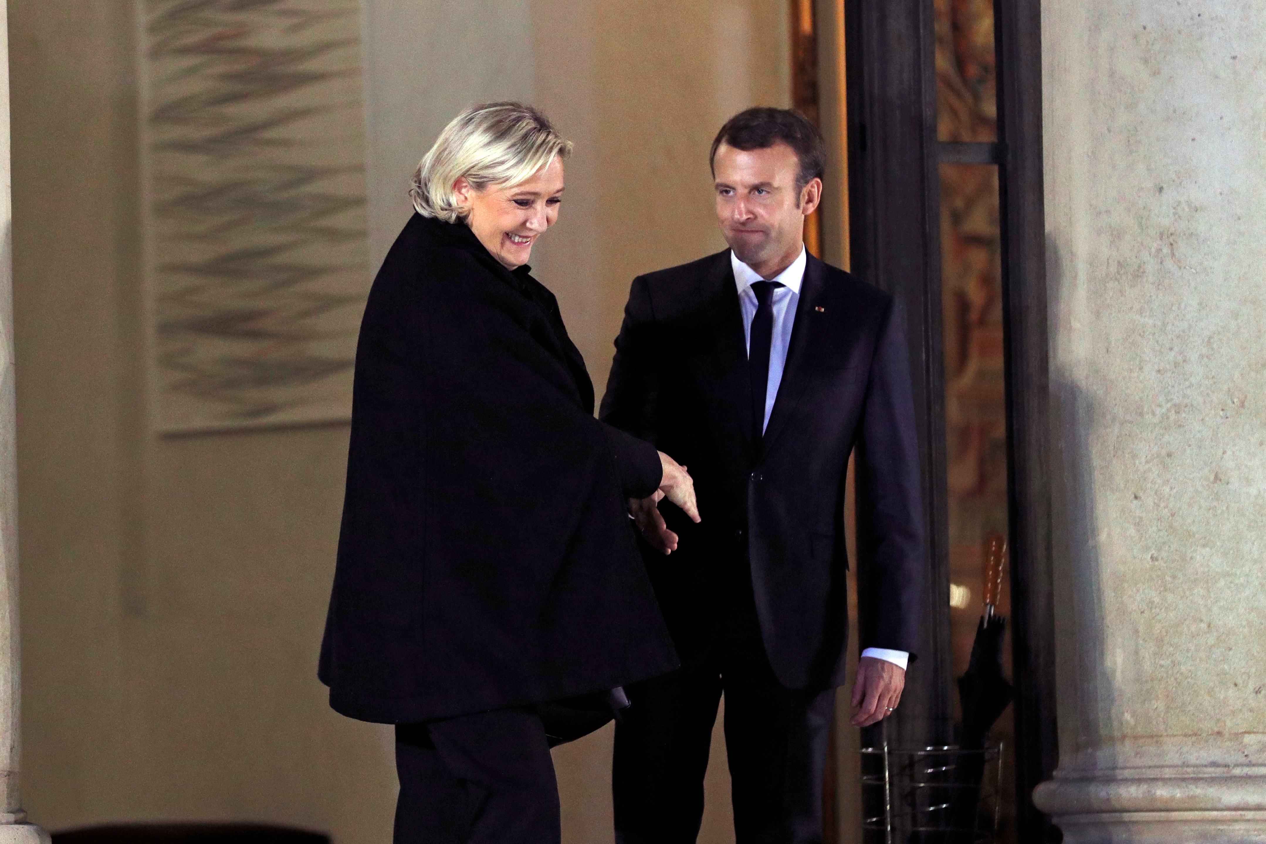 Macron accompanies Marine Le Pen following a meeting at the Elysee Palace in Paris, November 21, 2017. France votes in 18 months’ time, and Macron does not want to repeat 2017, when Le Pen made it through to the final round