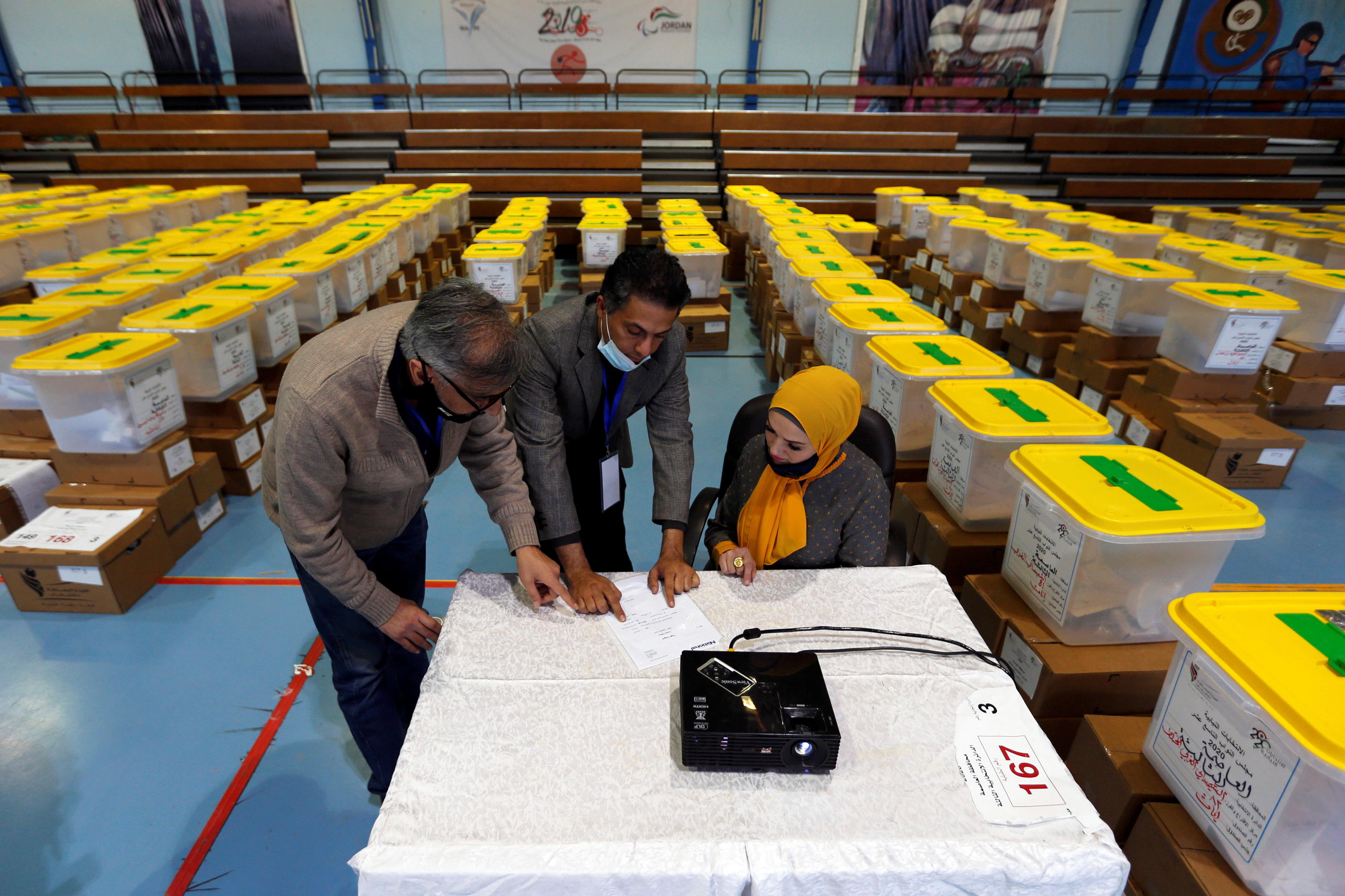 Jordanian election officials check ballot boxes at a vote counting centre in Amman