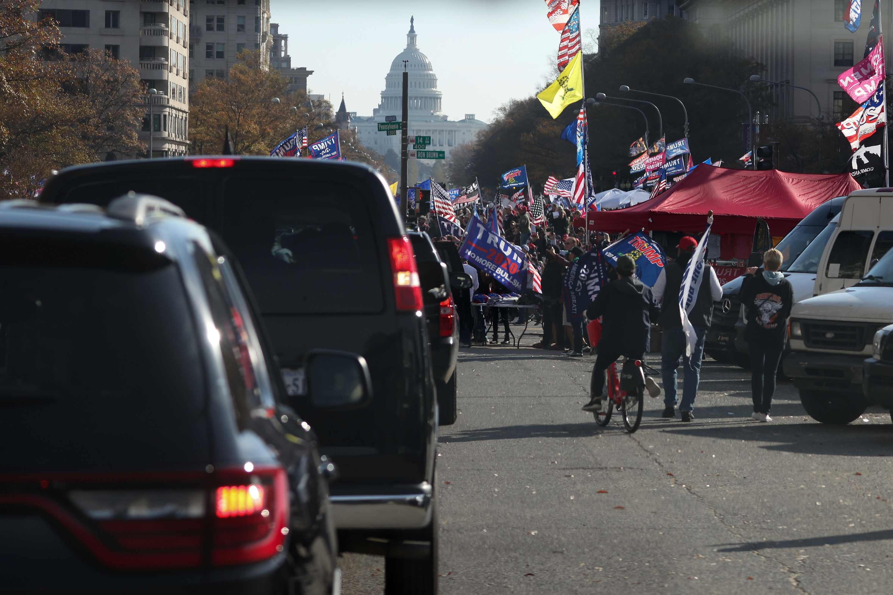 Supporters of President Donald Trump cheer alongside the presidential motorcade at Freedom Plaza near the White House in Washington, DC