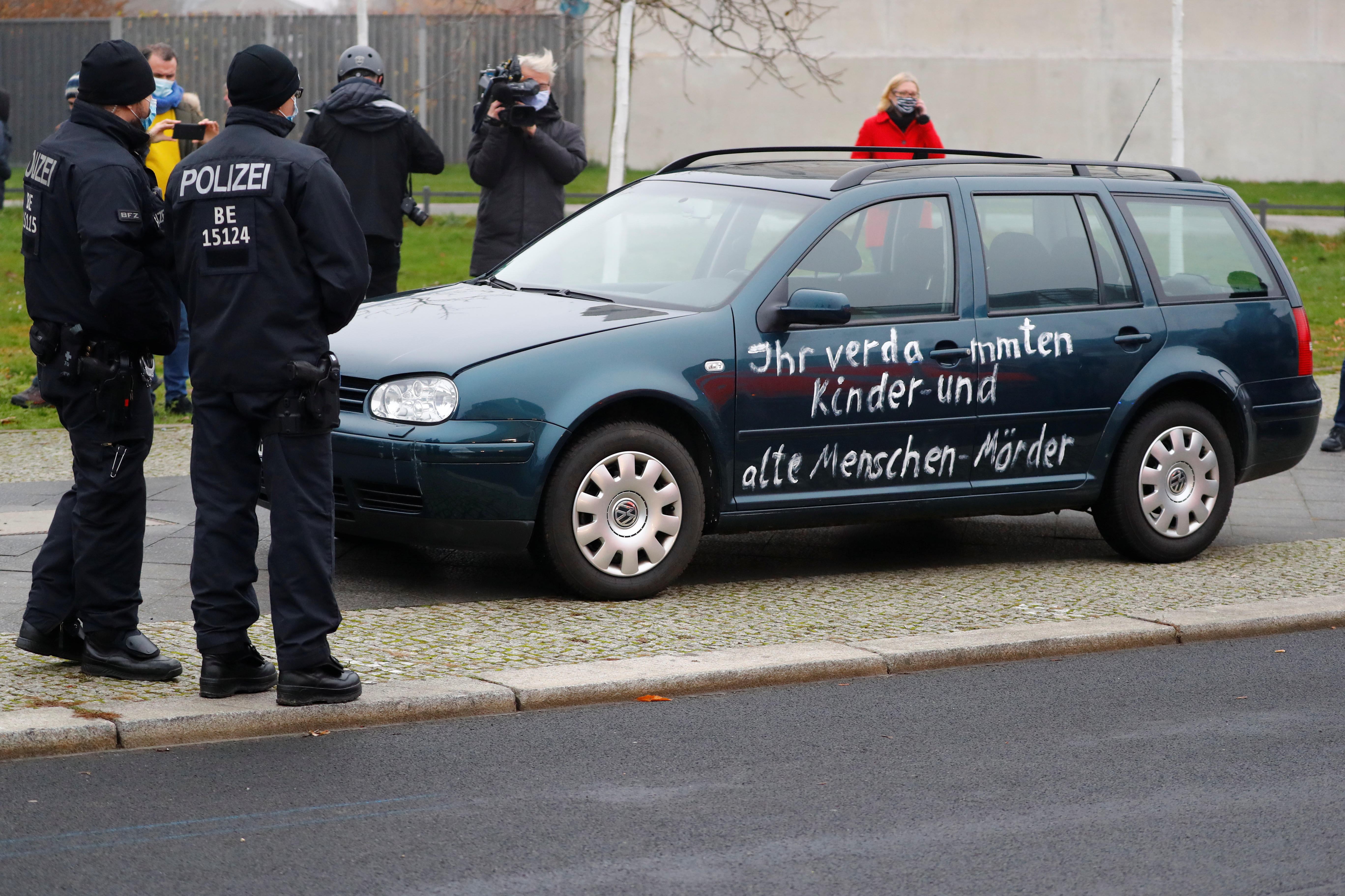 Journalists film the car which crashed into the gate of the main entrance of the chancellery in Berlin, the office of German Chancellor Angela Merkel in Berlin, Germany