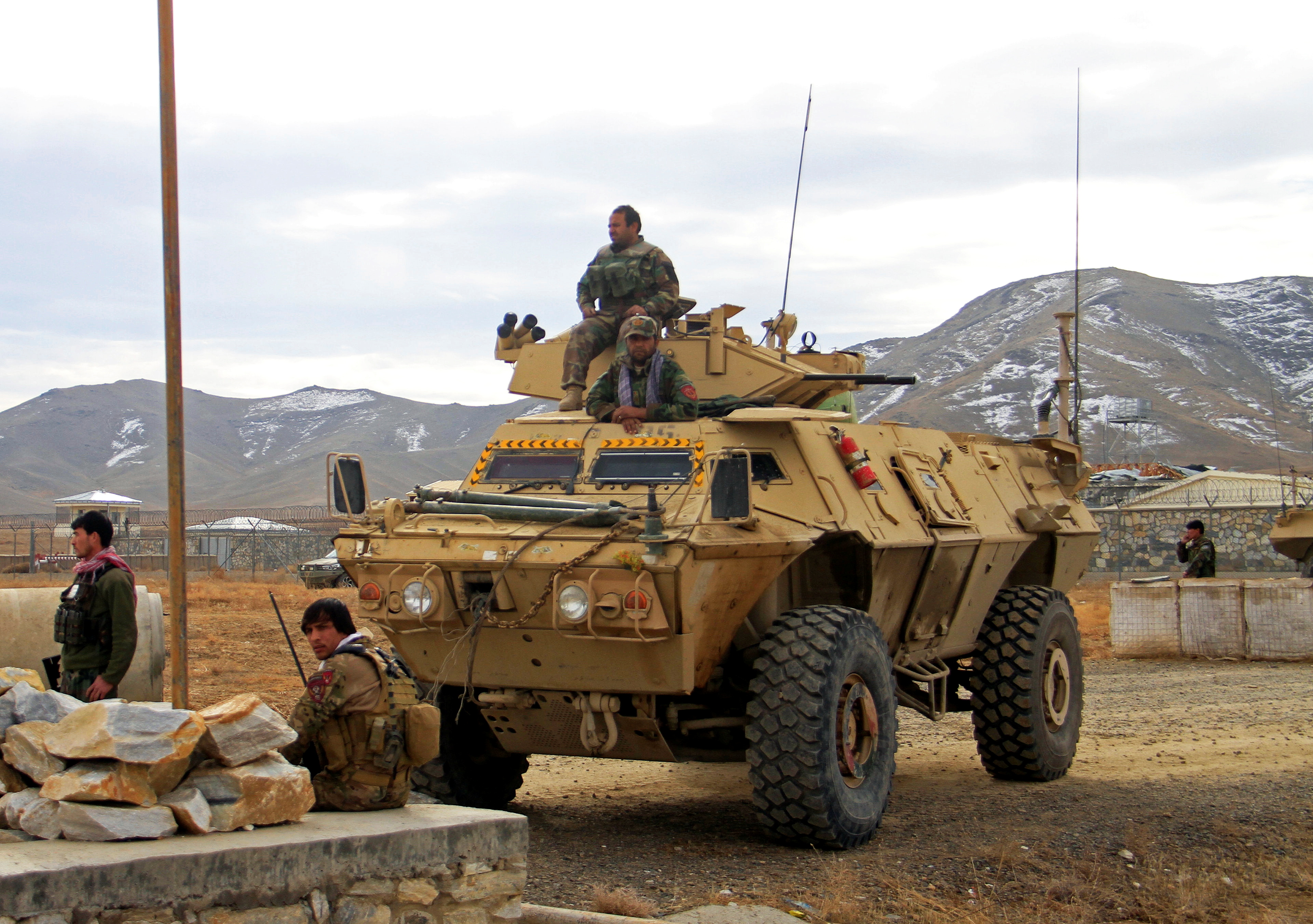 Afghan National Army soldiers keep watch outside the military compound on the outskirts of Ghazni