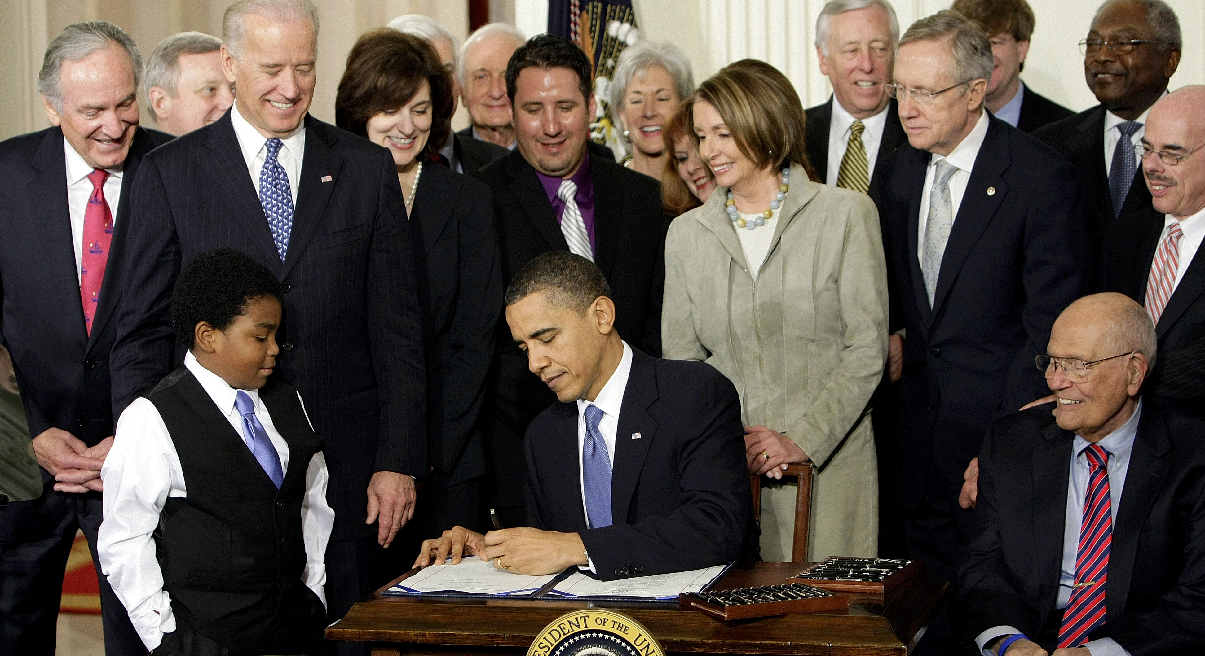 In a March 23, 2010 photo, President Barack Obama signs the Affordable Care Act in the East Room of the White House in Washington