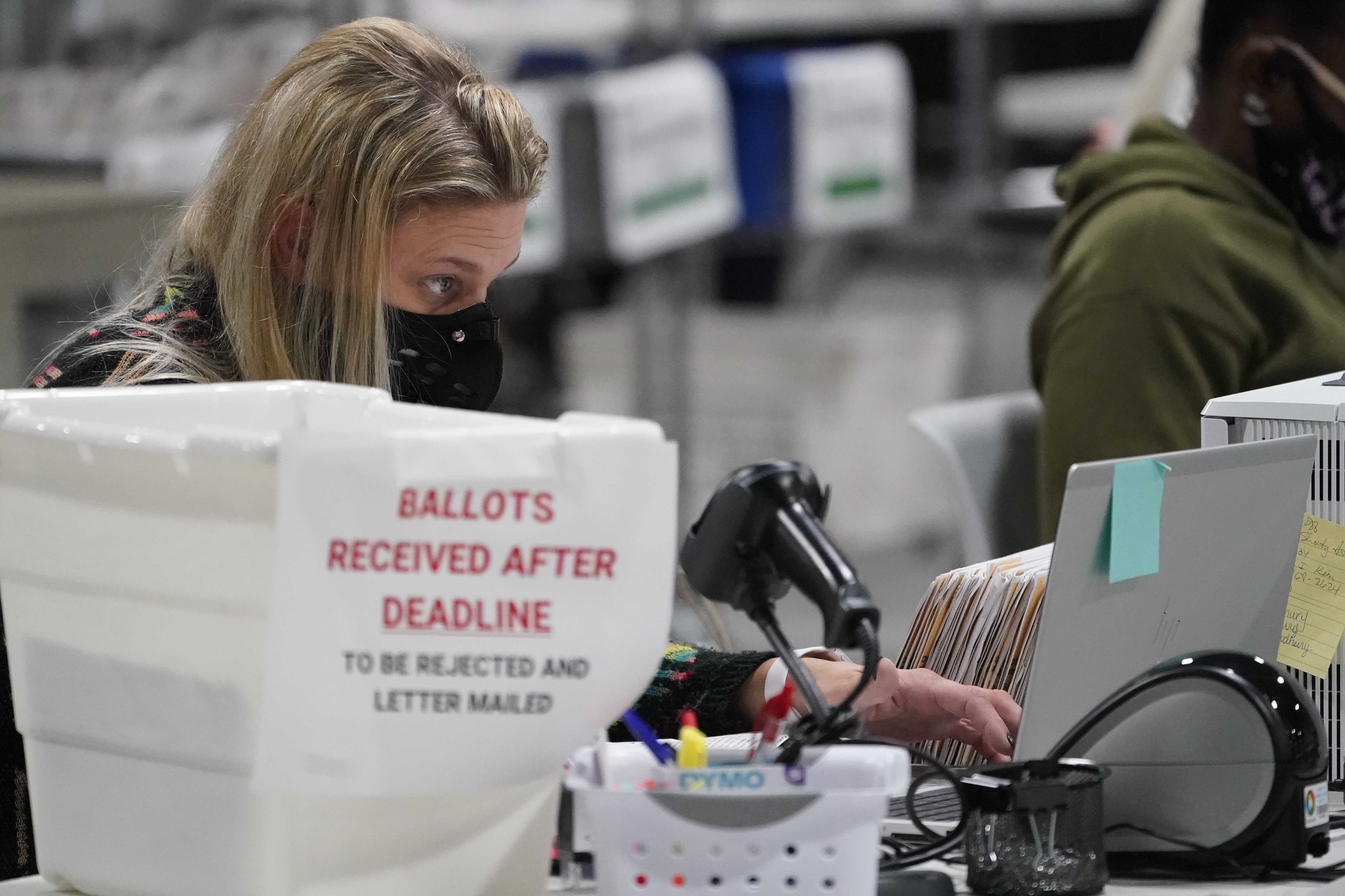 Officials work on ballots at the Gwinnett County Voter Registration and Elections Office, in Lawrenceville, near Atlanta