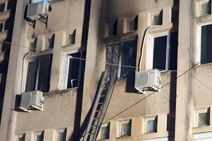 The facade of the hospital is blackened by smoke from the ICU unit