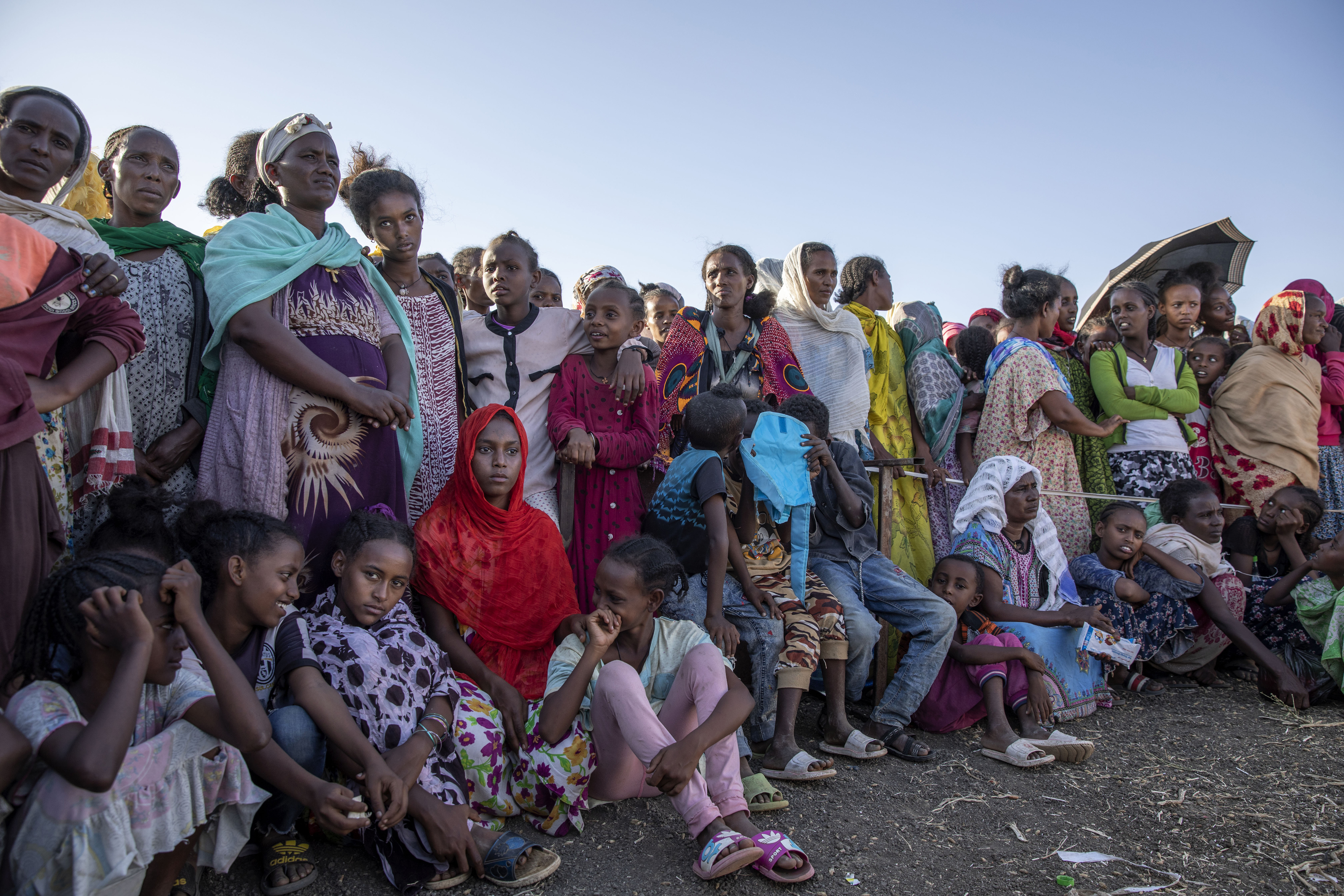 Tigray refugees who fled the conflict wait to receive aid at a transit centre near the Lugdi border crossing in eastern Sudan