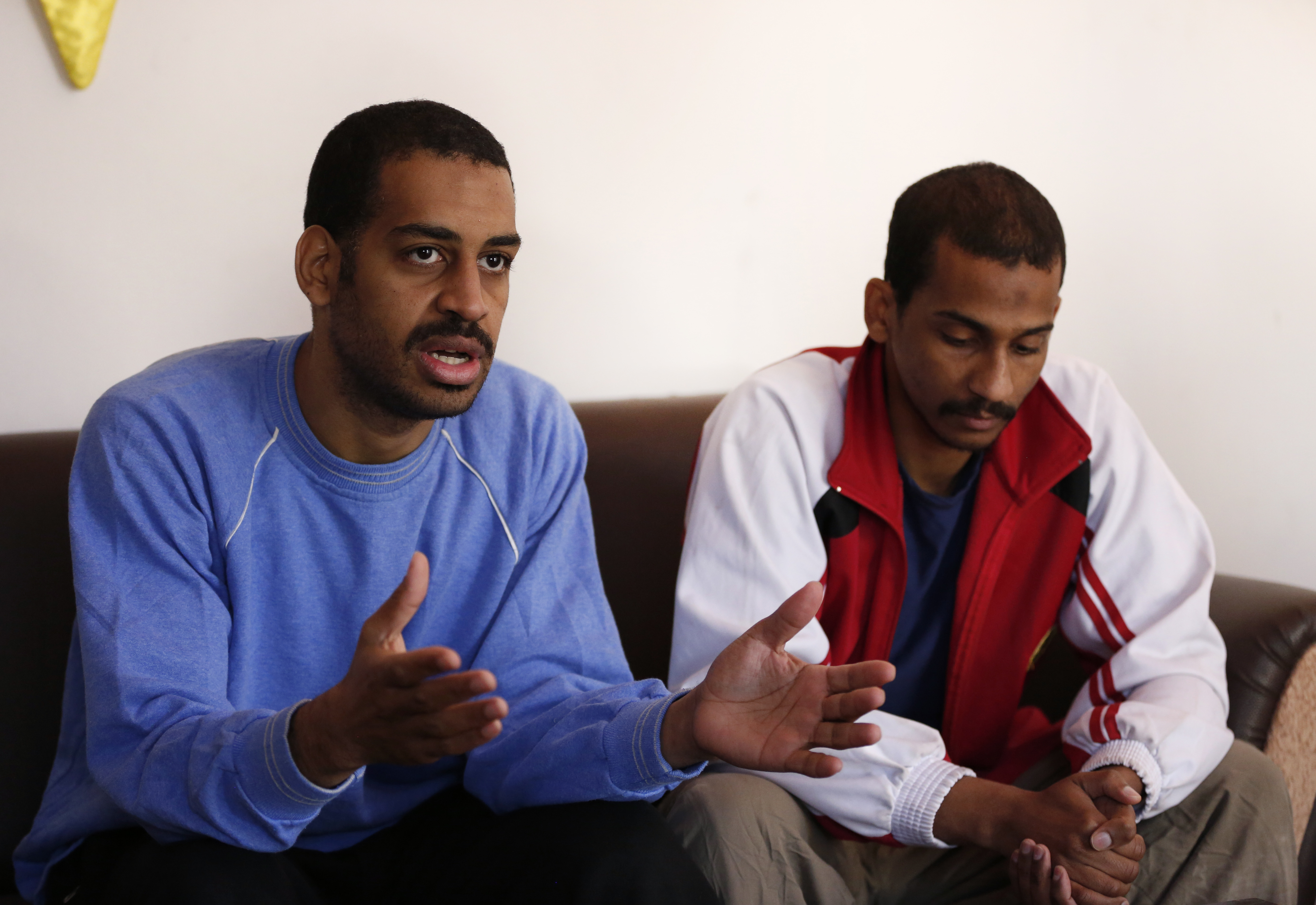 Alexanda Kotey (L) and El Shafee Elsheikh (R) speak during an interview with The Associated Press at a security centre in Kobane, Syria